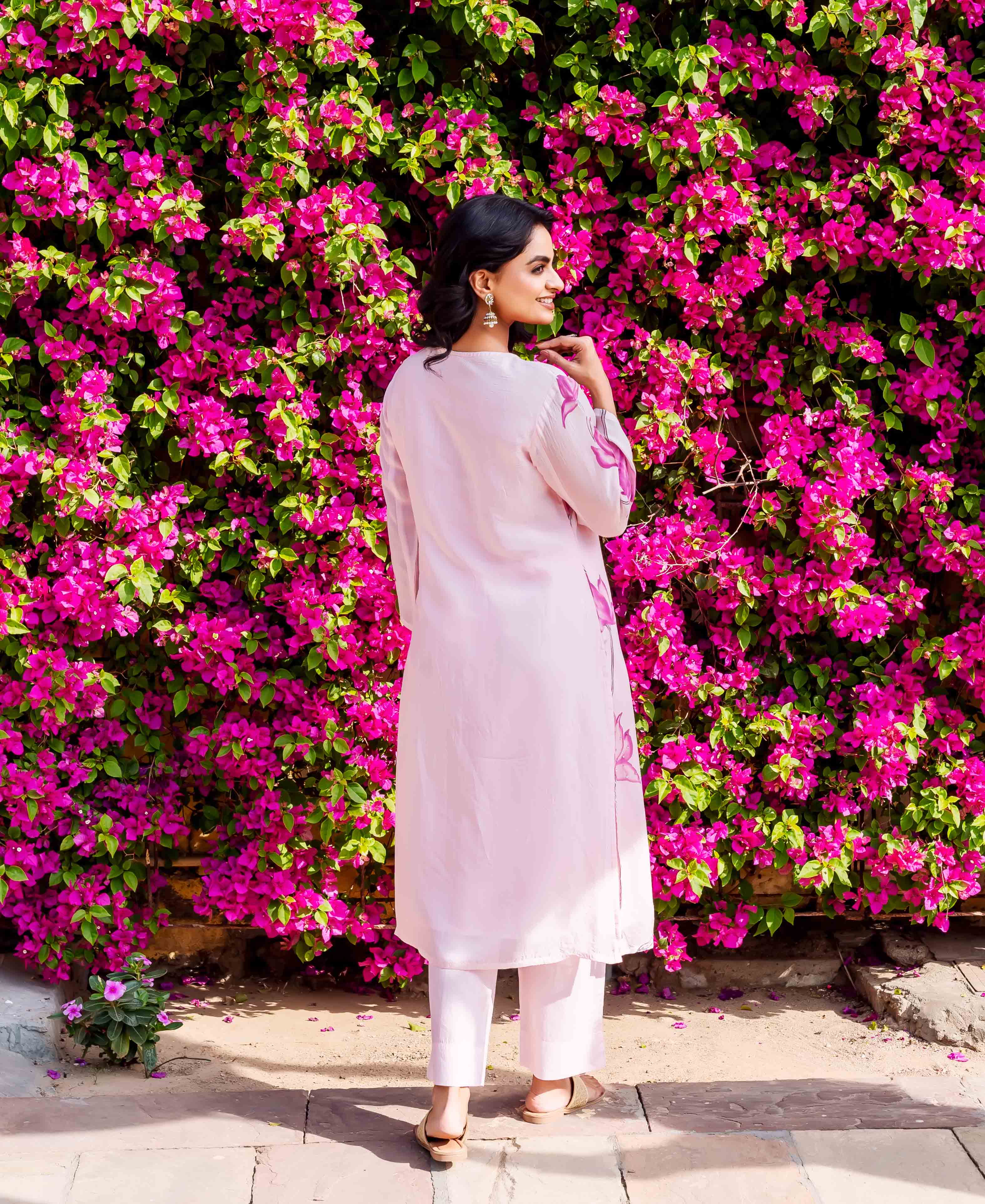 Full back view of model in light pink kurta set with vibrant hand-block-printed patterns.