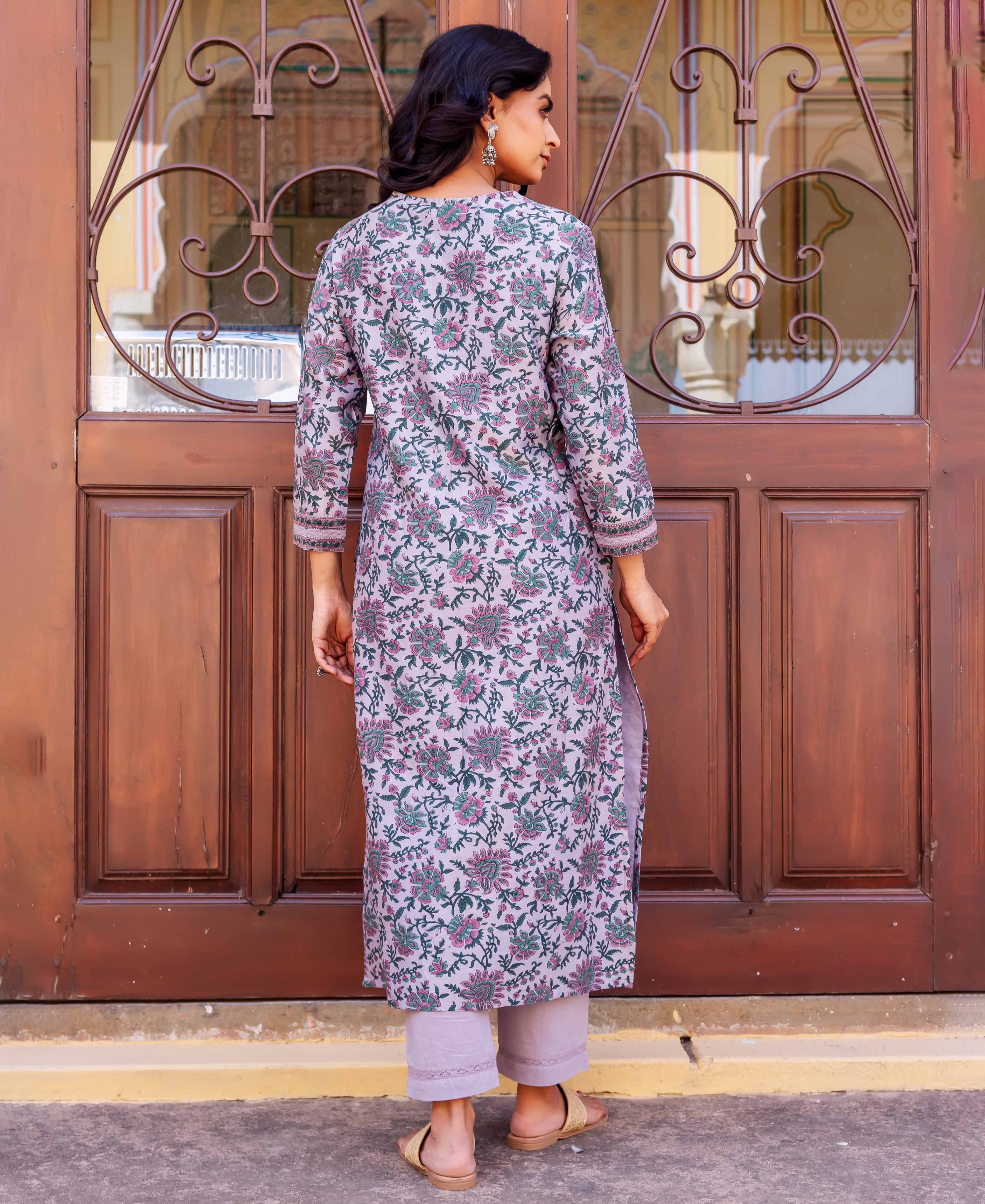 Woman wears long lilac tunic with pink and green floral hand-block print and cropped trousers.