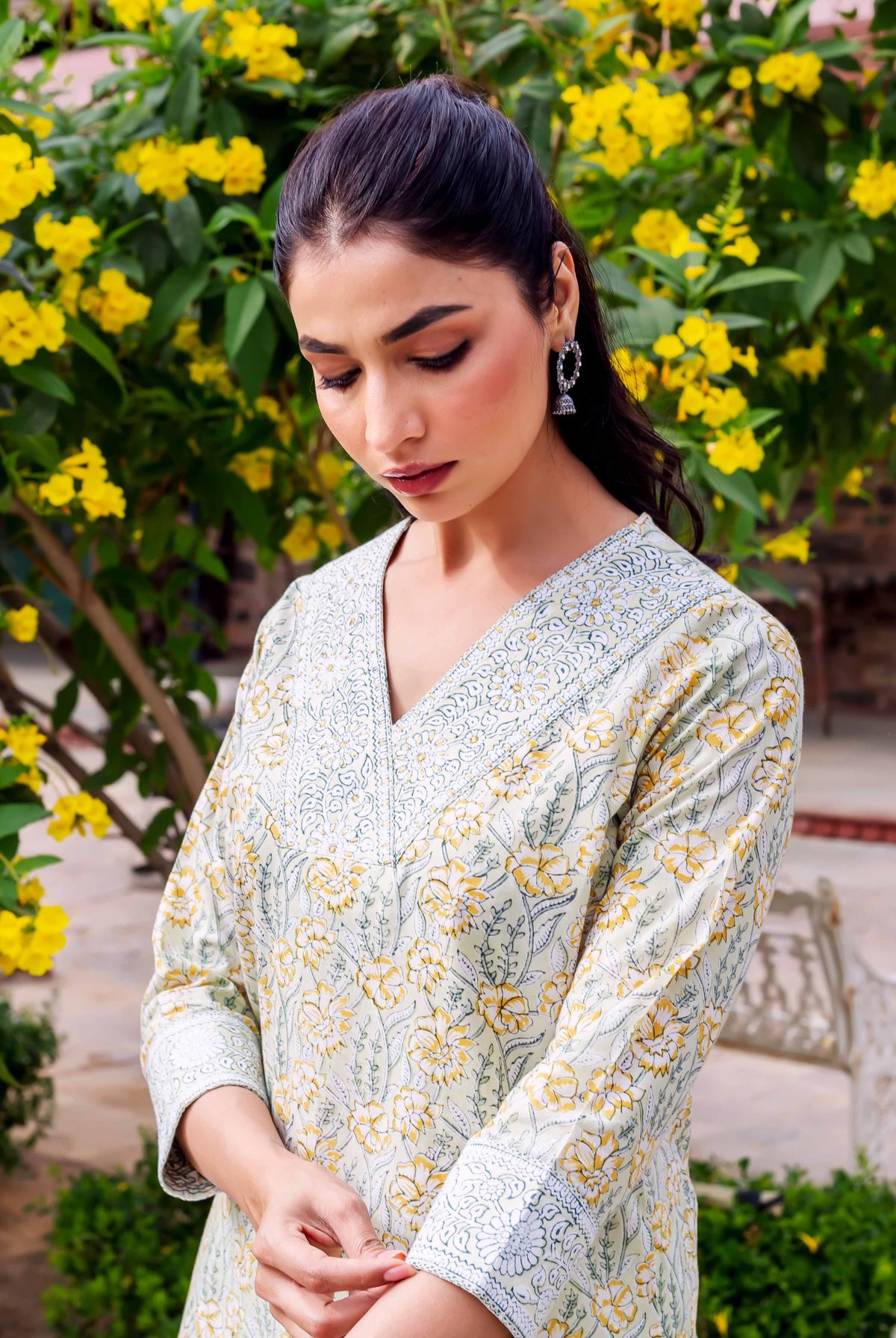 Woman in mint cotton kurta with yellow and green floral hand-block print.