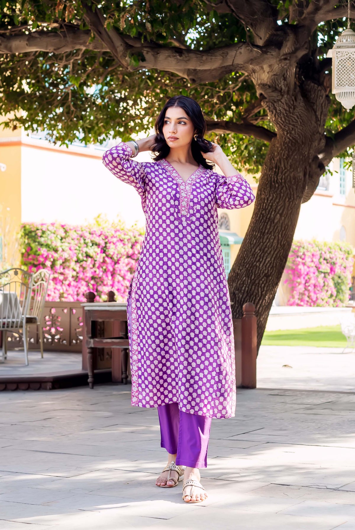 Purple hand-block-printed chanderi kurta with white polka dots and embroidered neckline on a model outdoors.