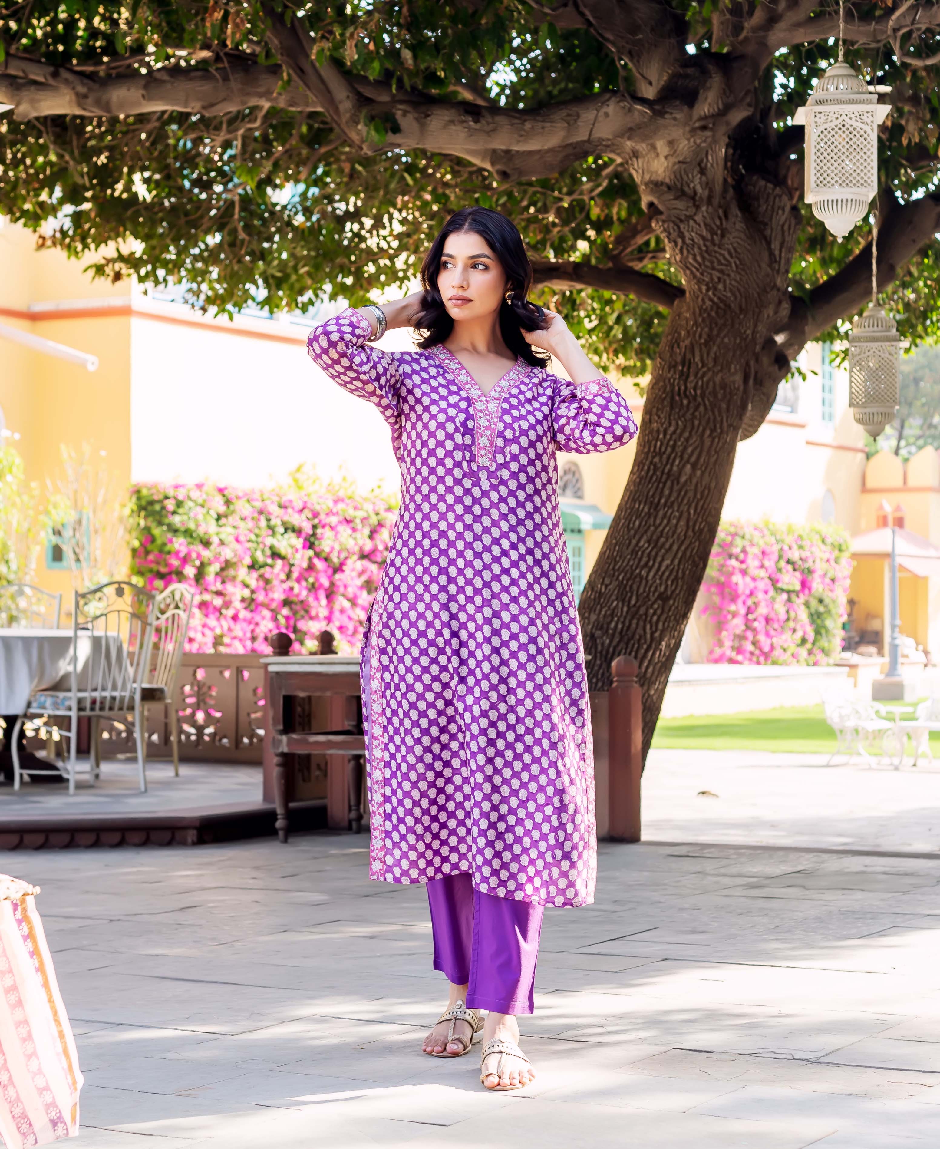 Purple hand-block-printed chanderi kurta with white polka dots and embroidered neckline on a model outdoors.