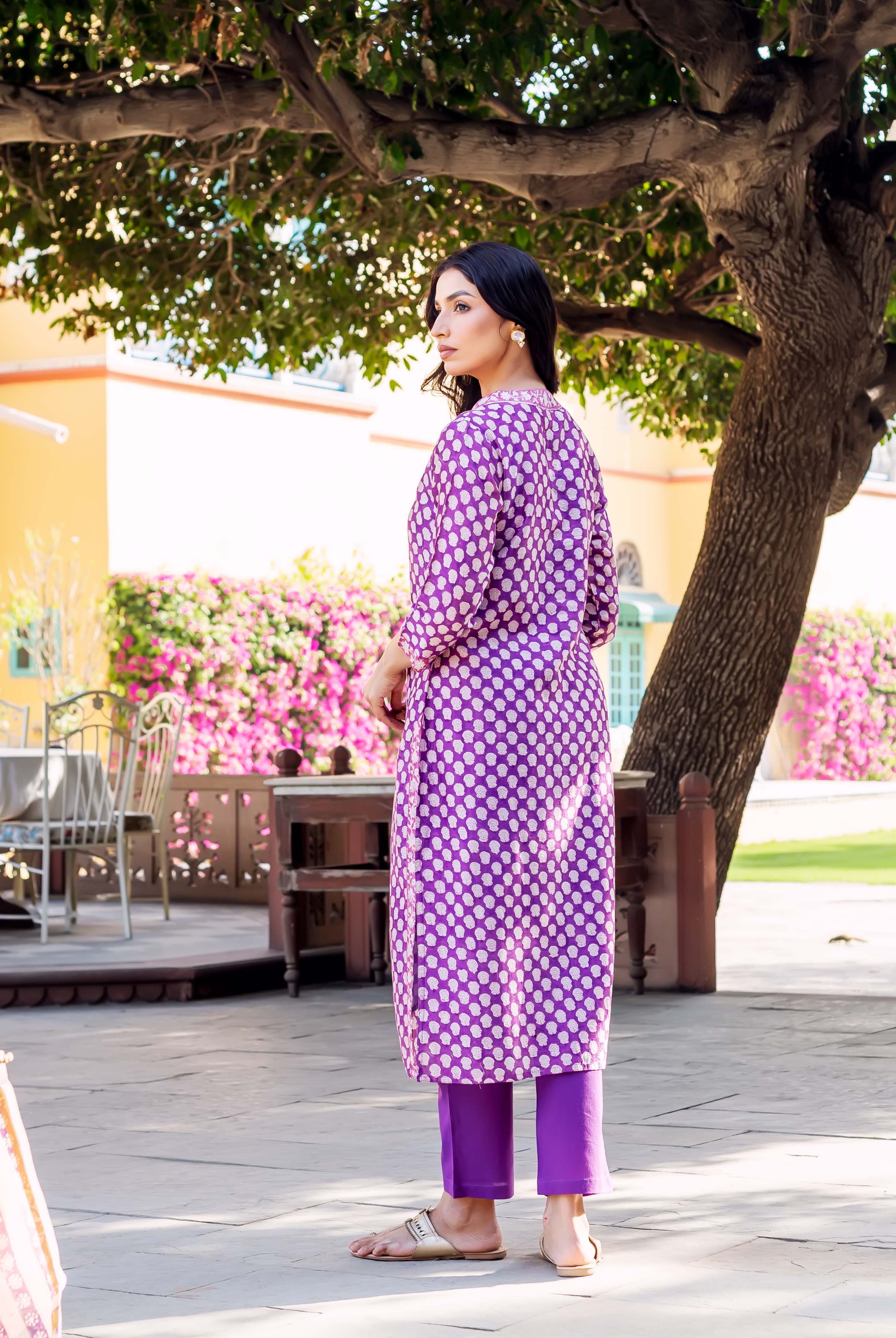 Woman wears purple Chanderi kurta with white polka dots and matching purple pants.