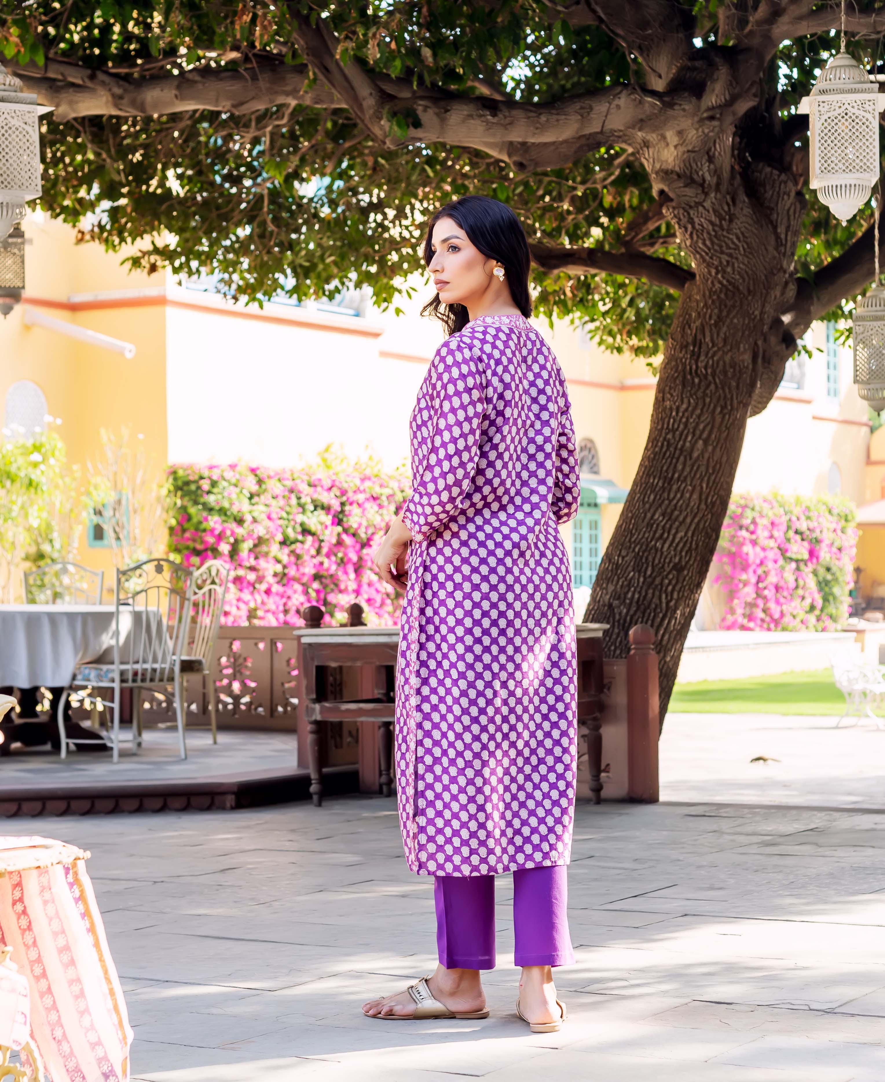 Woman wears purple Chanderi kurta with white polka dots and matching purple pants.