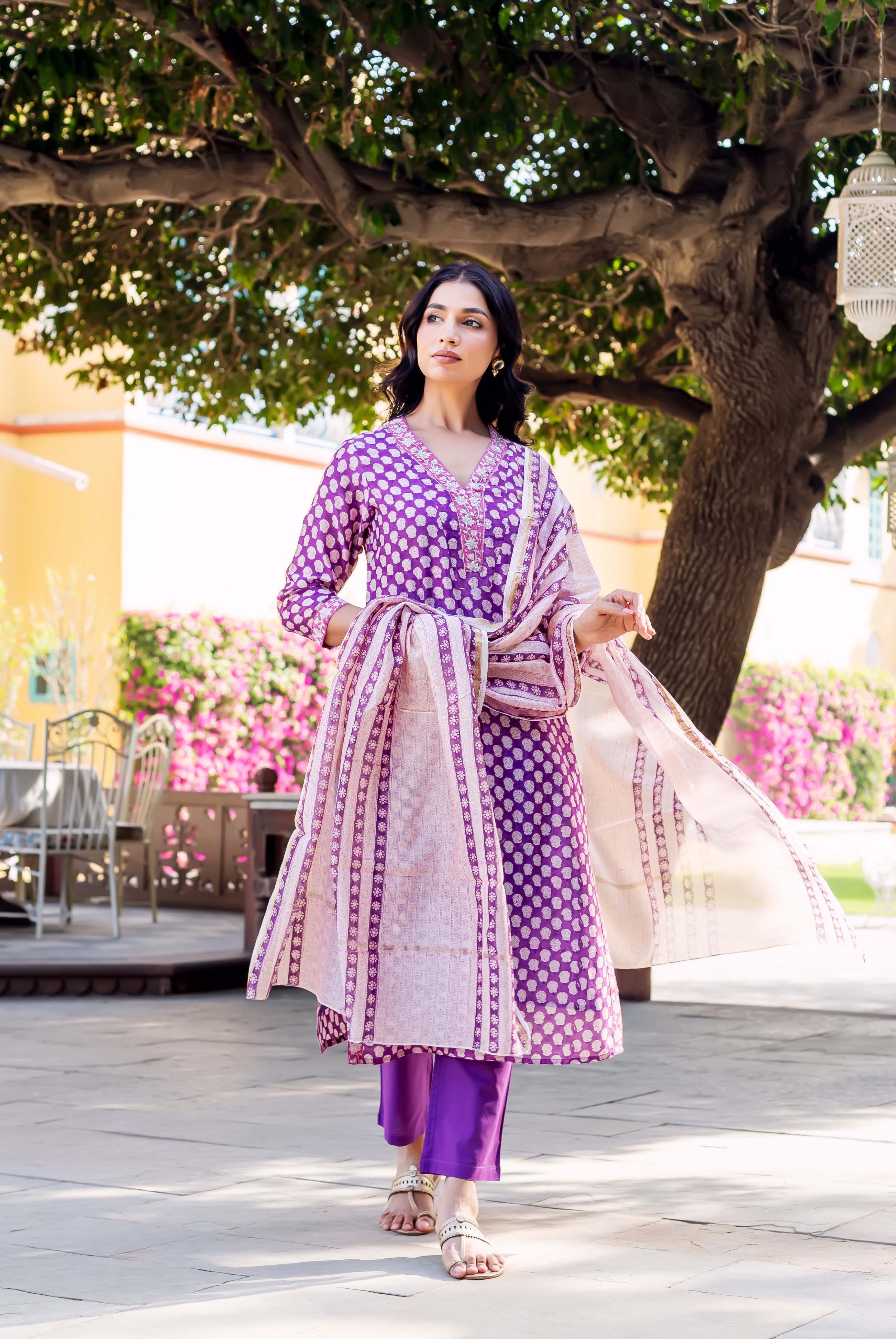 Model in purple hand-block-printed kurta set with white polka dots and patterned dupatta.