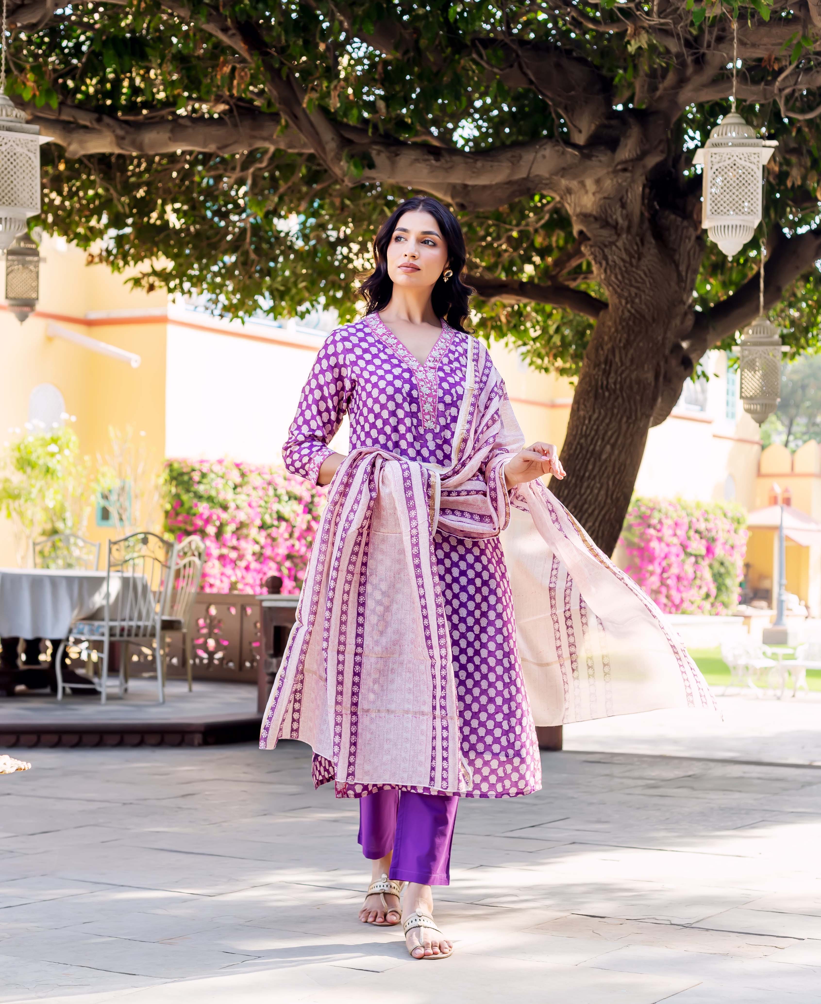 Model in purple hand-block-printed kurta set with white polka dots and patterned dupatta.