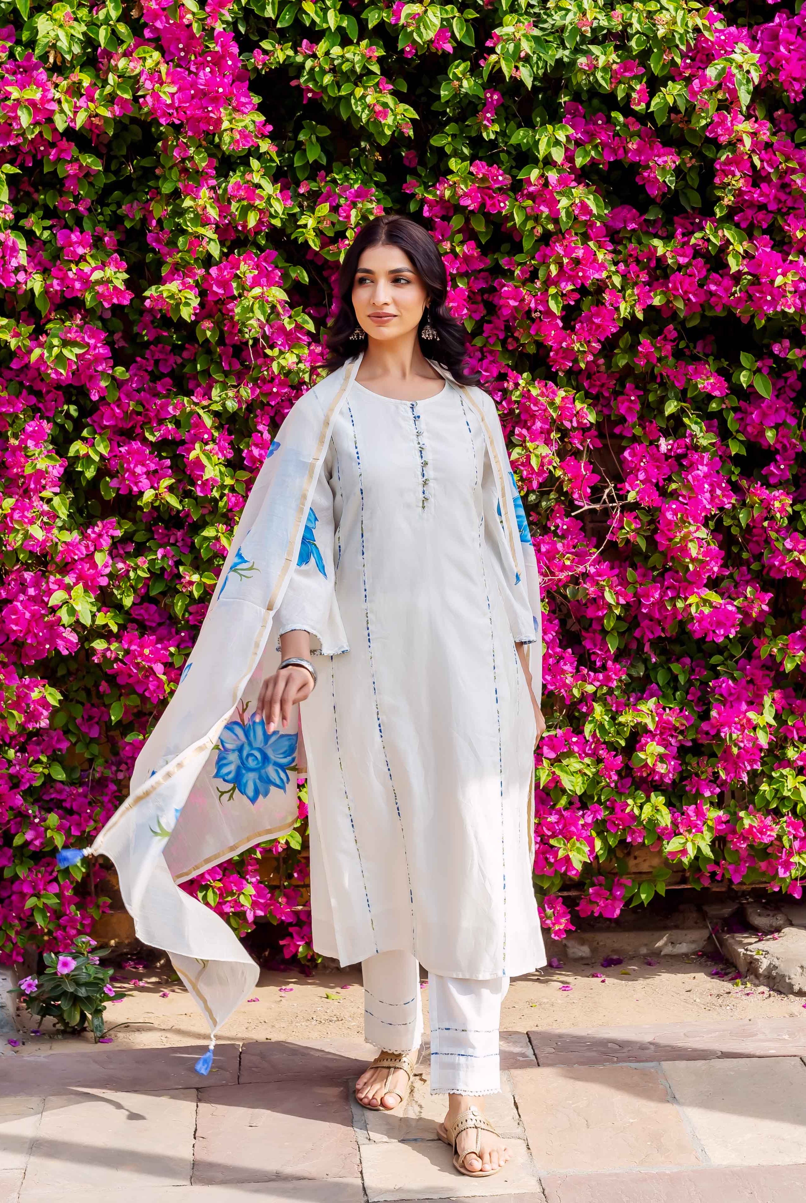 Front full look of model in white ethnic kurta set with blue brush-painted floral dupatta.