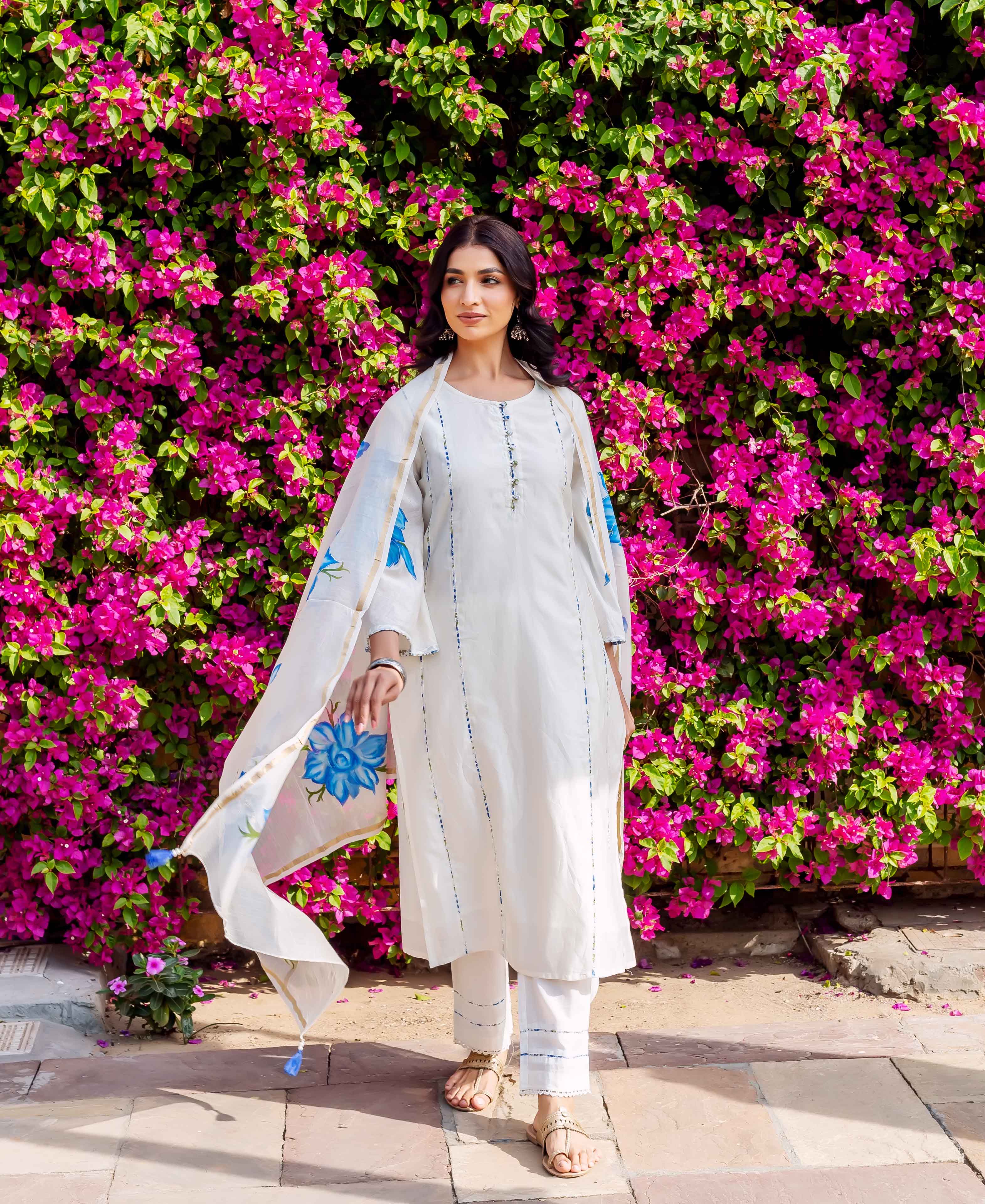 Front full look of model in white ethnic kurta set with blue brush-painted floral dupatta.