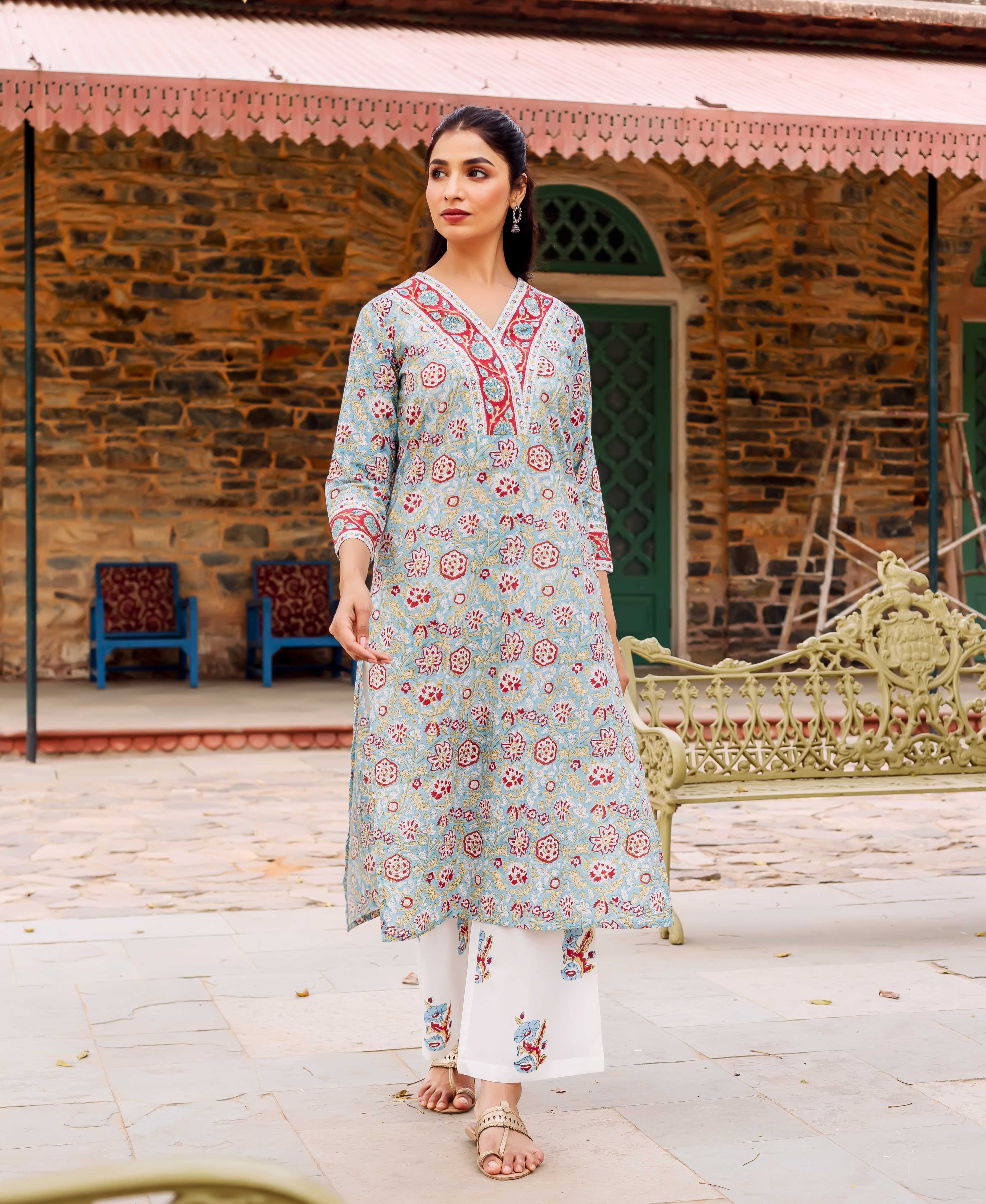 A model wearing a teal cotton kurta with red and white floral print.