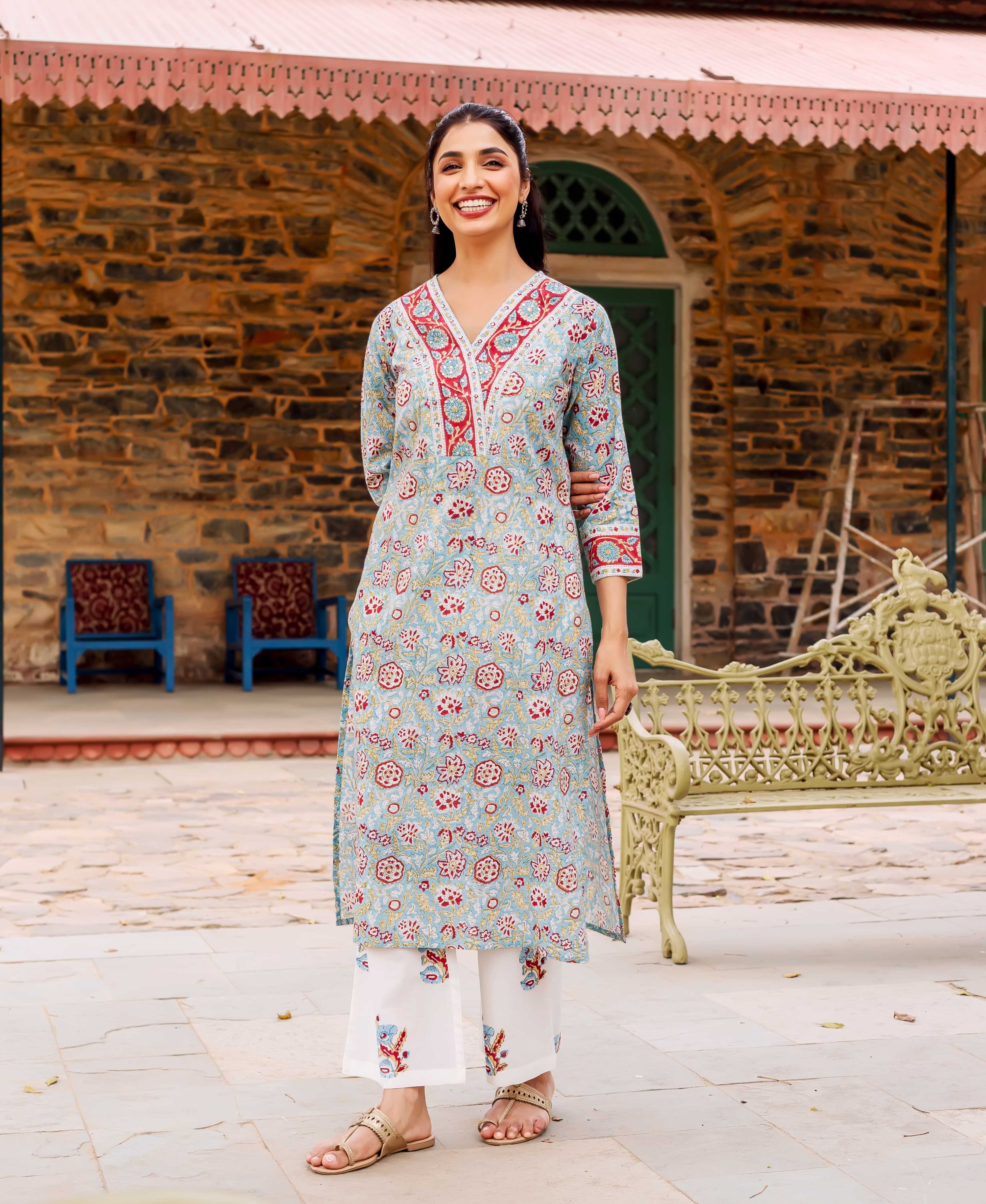 A model wearing a teal cotton kurta with red and white floral print.