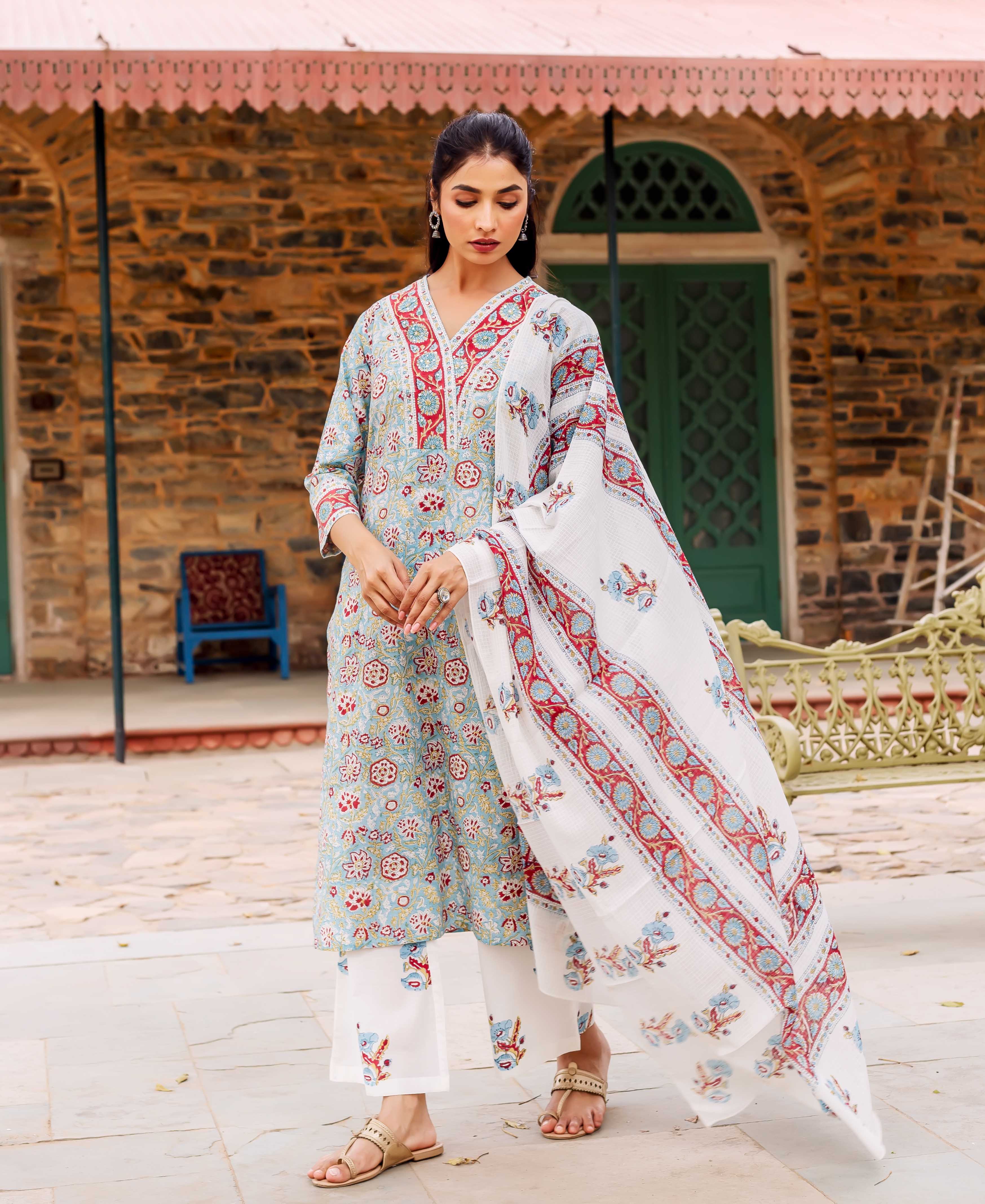 A model wearing a teal, red, and white hand-block-printed kurta with a matching dupatta.