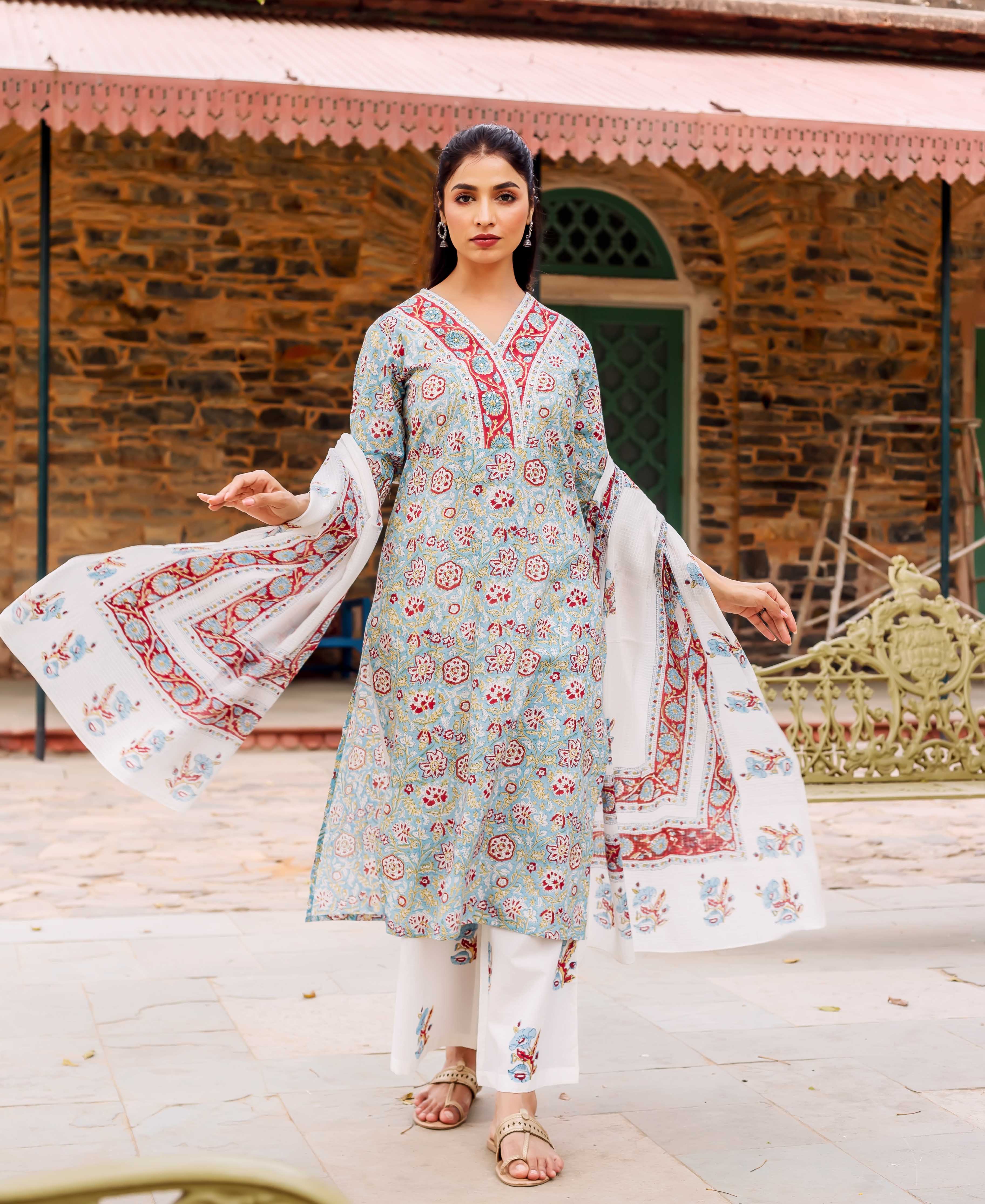 Teal kurta with red, white and yellow hand-block print, on a model outdoors.