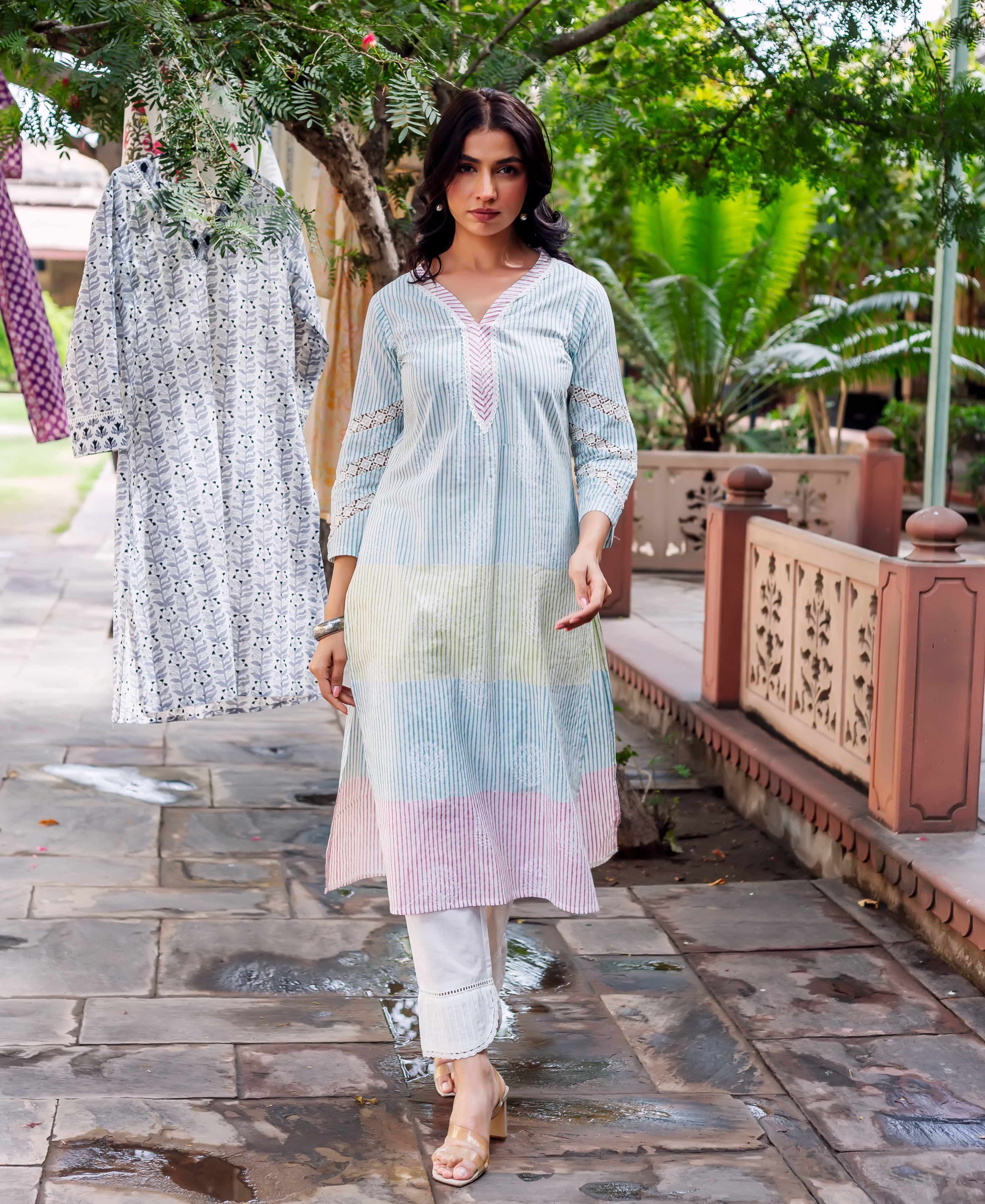 Front full look of a model wearing a pastel striped hand-block printed cotton kurta.