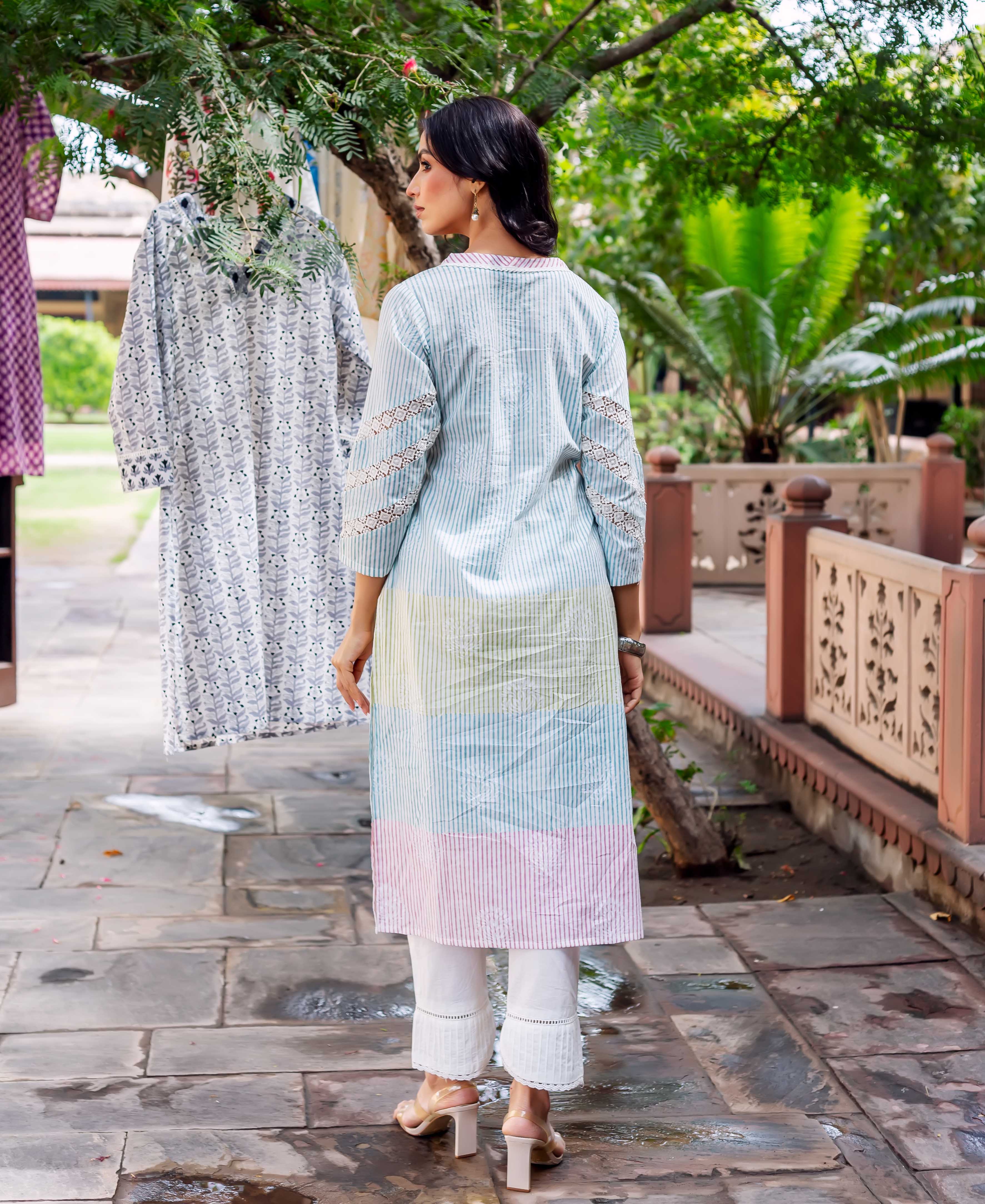 Model's back in a pastel striped kurta featuring subtle hand-block print and lace sleeves.