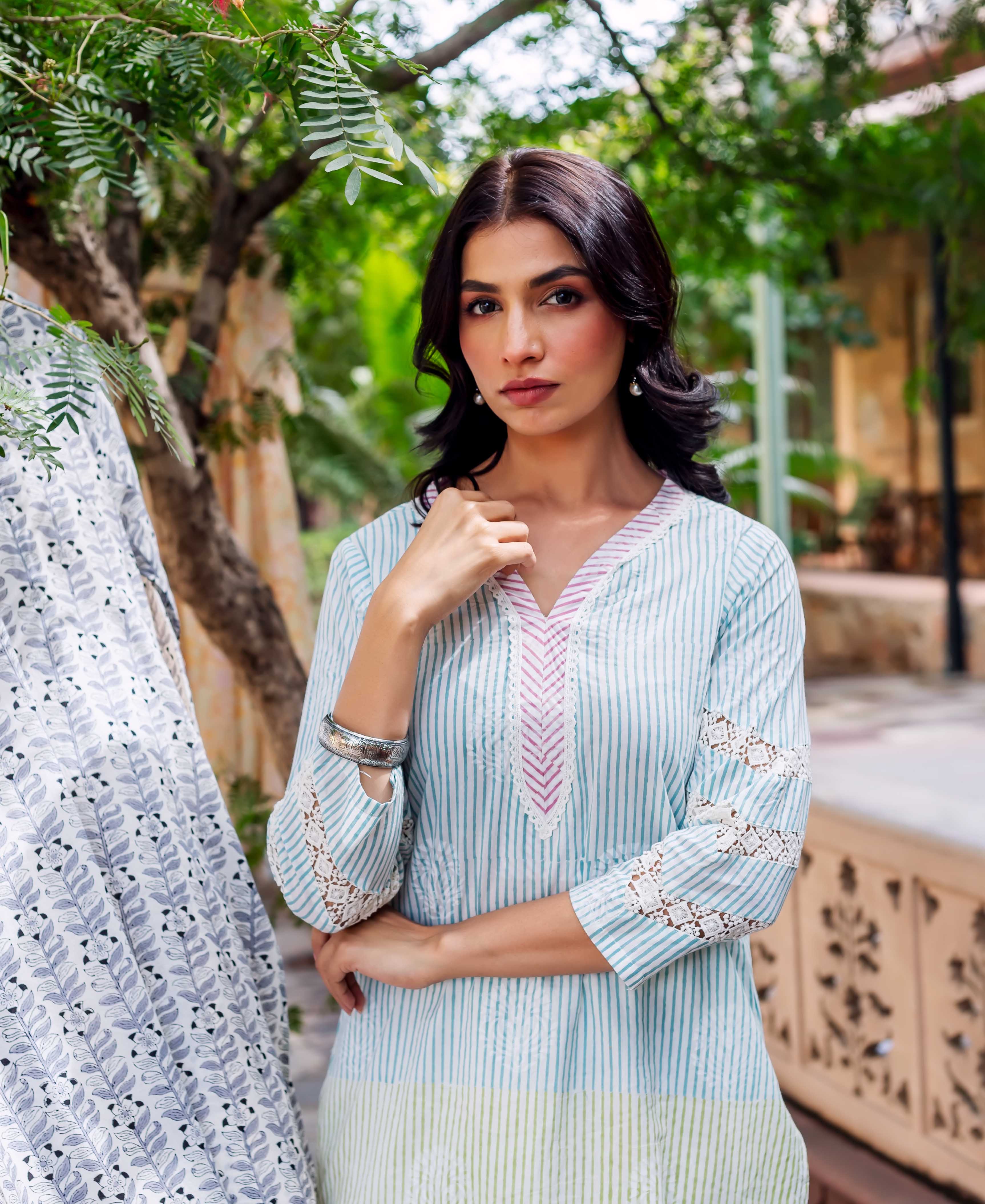 Pastel striped cotton kurta on model with pink yoke, lace sleeves, and green panel.
