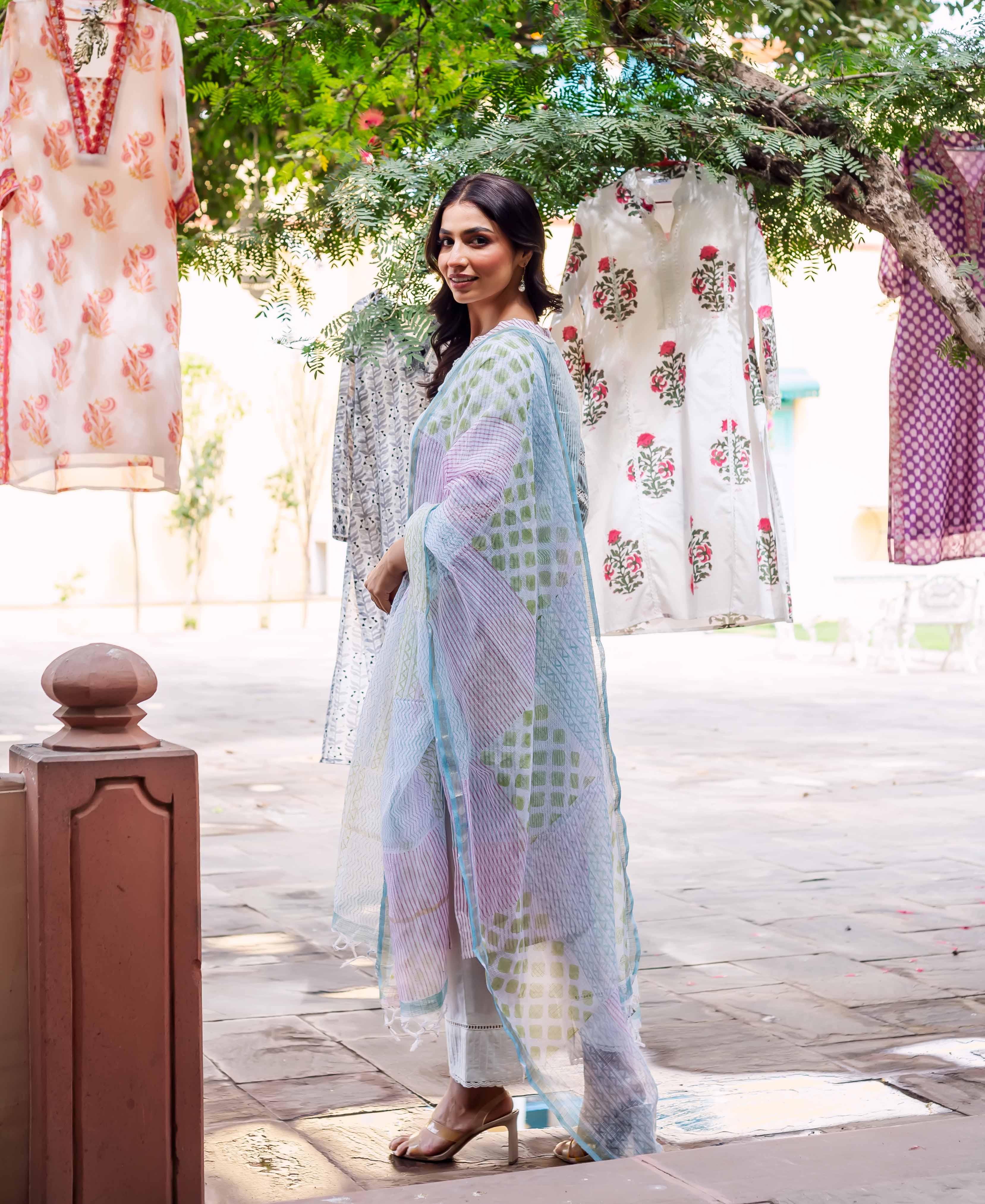 Model in a white kurta set, showcasing a pastel geometric sheer dupatta.