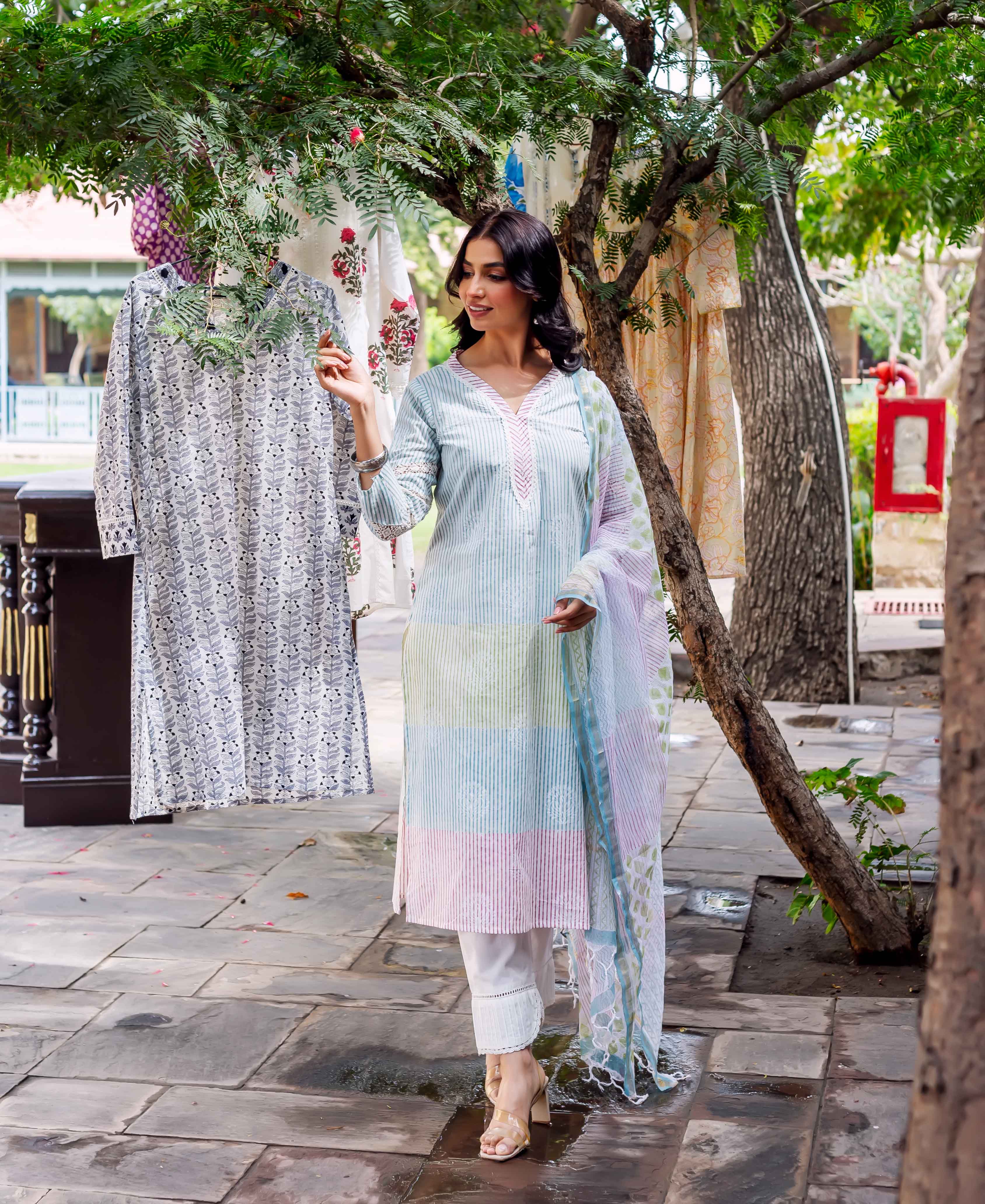 Front view model in pastel hand-block printed color-block striped kurta set.