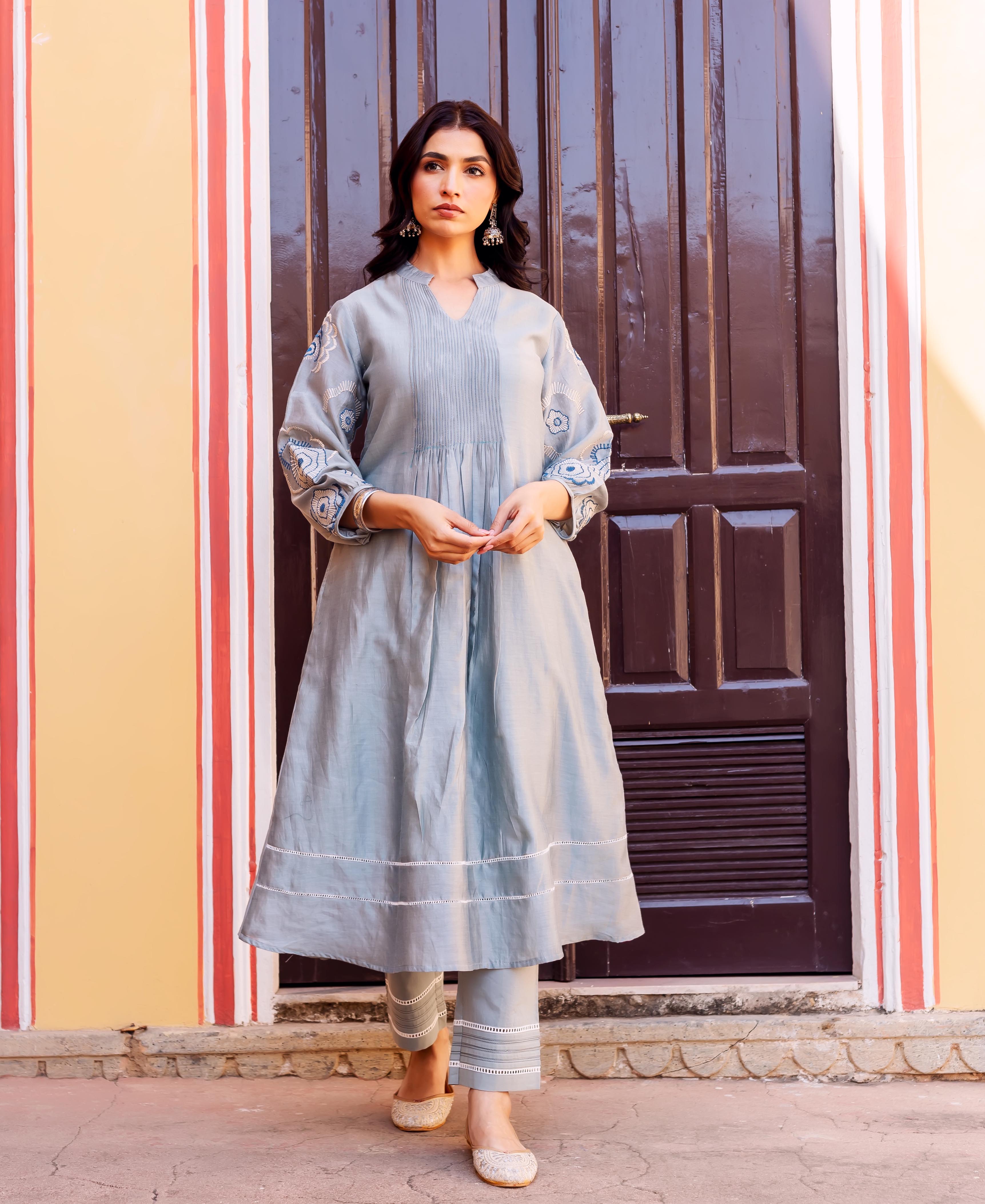Front shot of model wearing a slate blue Chanderi silk kurta with patterned sleeves and pants.