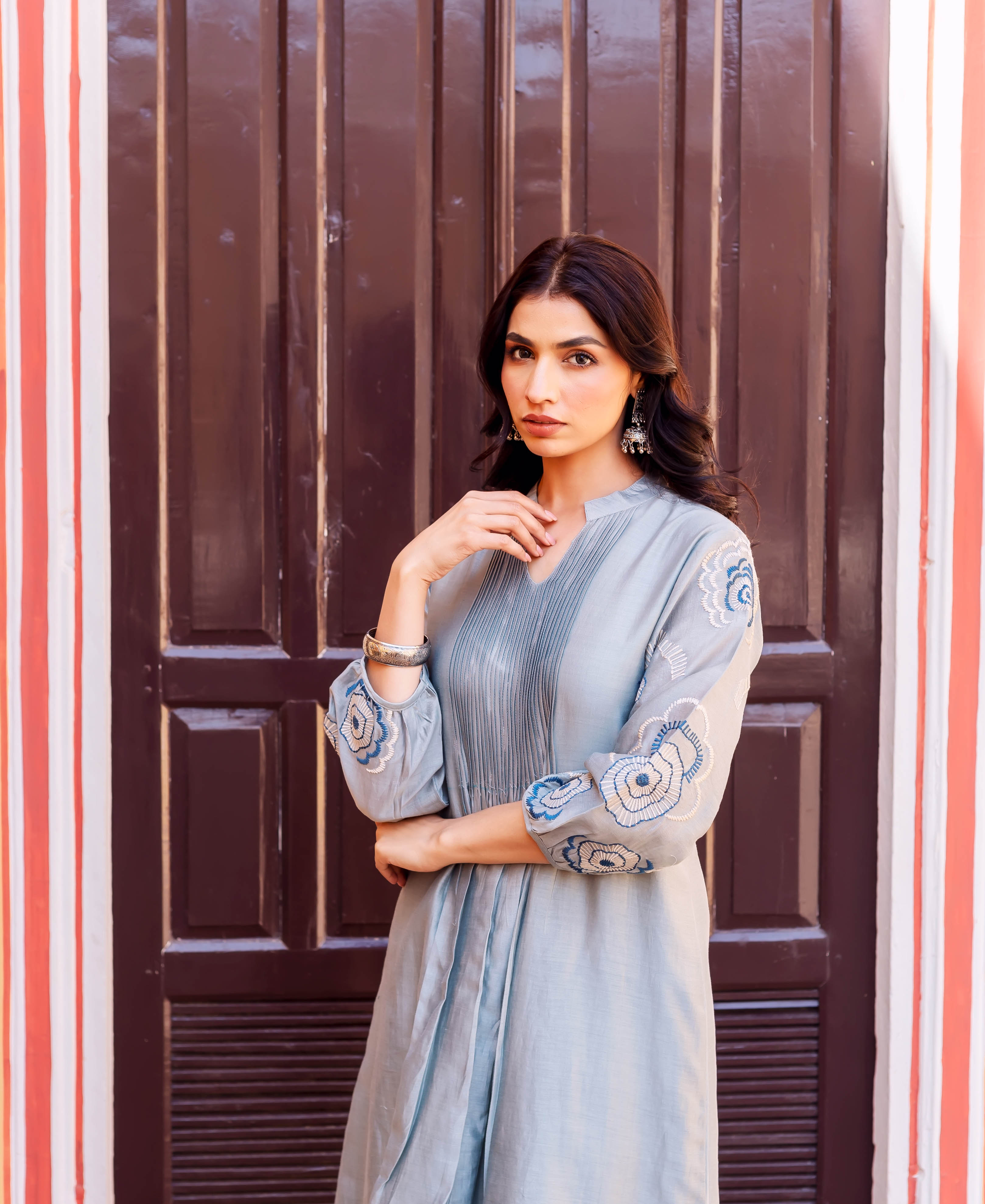 Front-facing model wears a slate blue Chanderi silk kurta with blue-white embroidered sleeves.