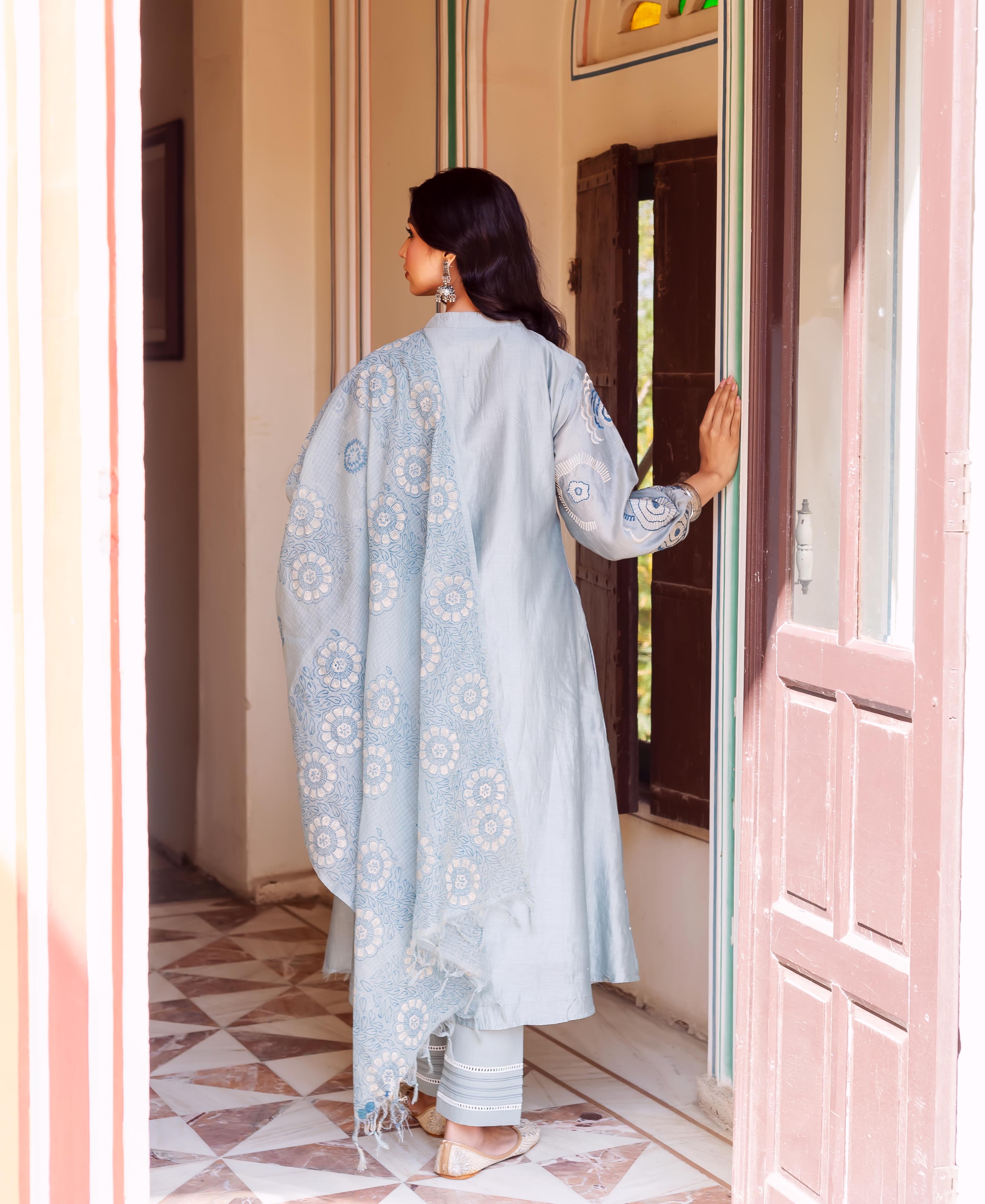 Rear view of model in slate blue hand-block printed Chanderi silk kurta with matching dupatta.