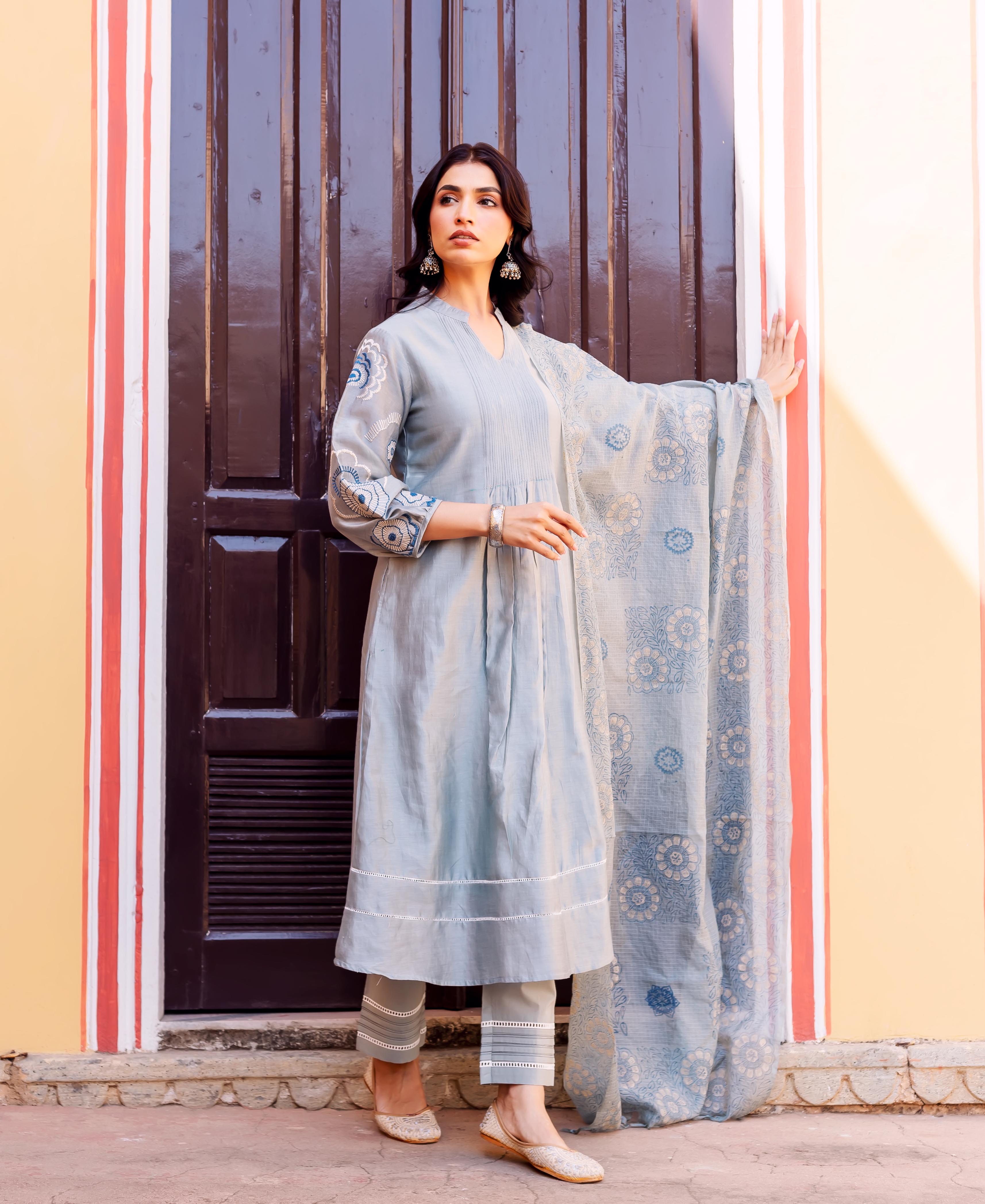 Full-body front view of a model wearing a slate blue hand-block-printed floral kurta set.
