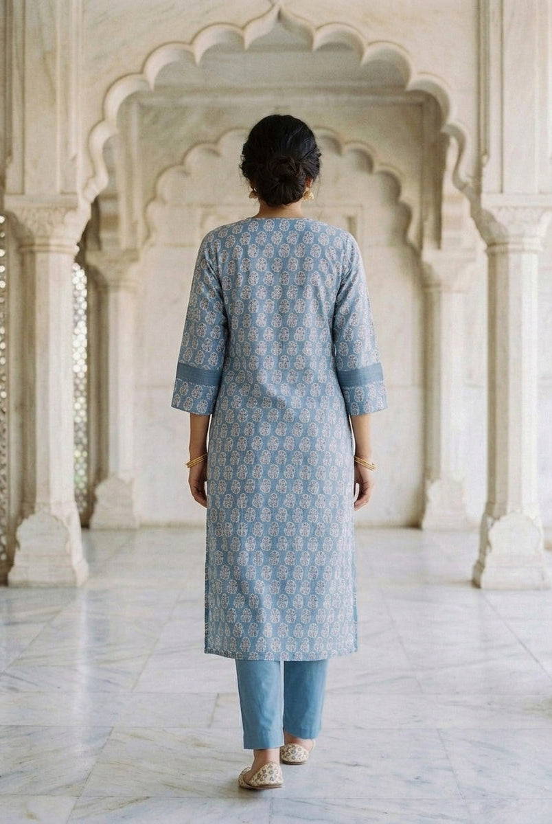 Back view of a model in dusty blue block print kurti with matching pants.