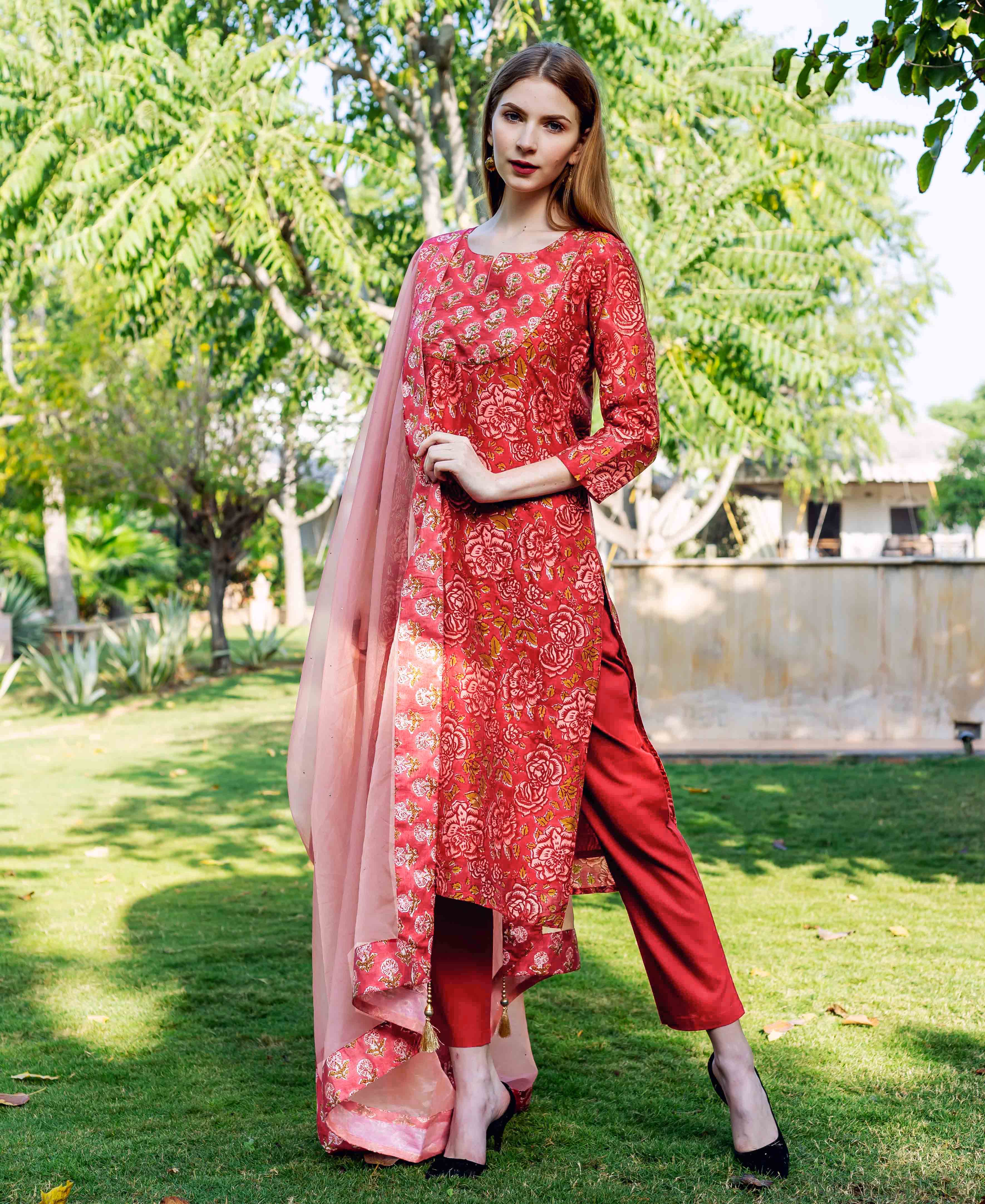 Full-length model in red floral print straight kurta set with pink dupatta.