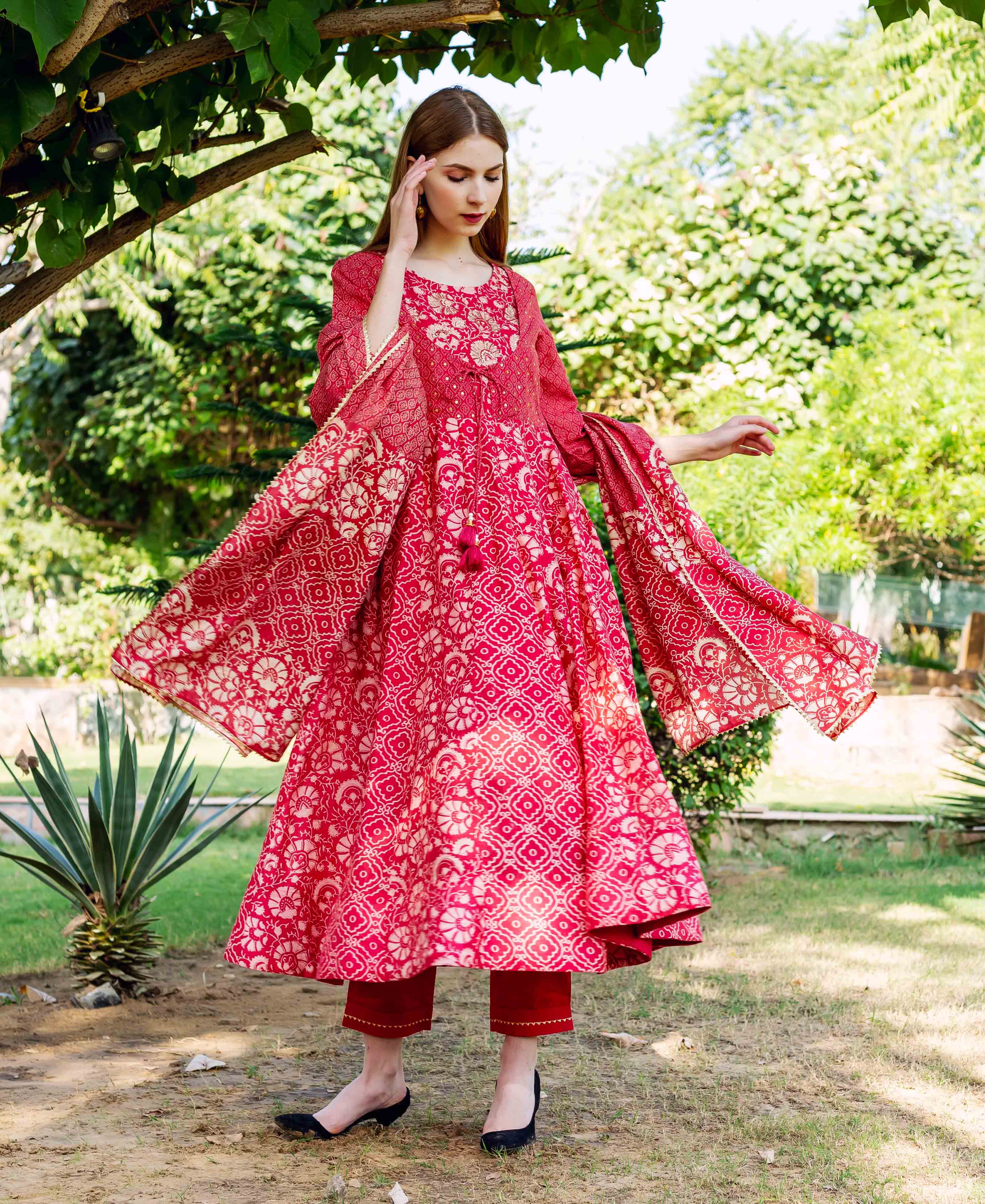 Full body model wearing a red and cream hand block printed ethnic piece, flowing dupatta.