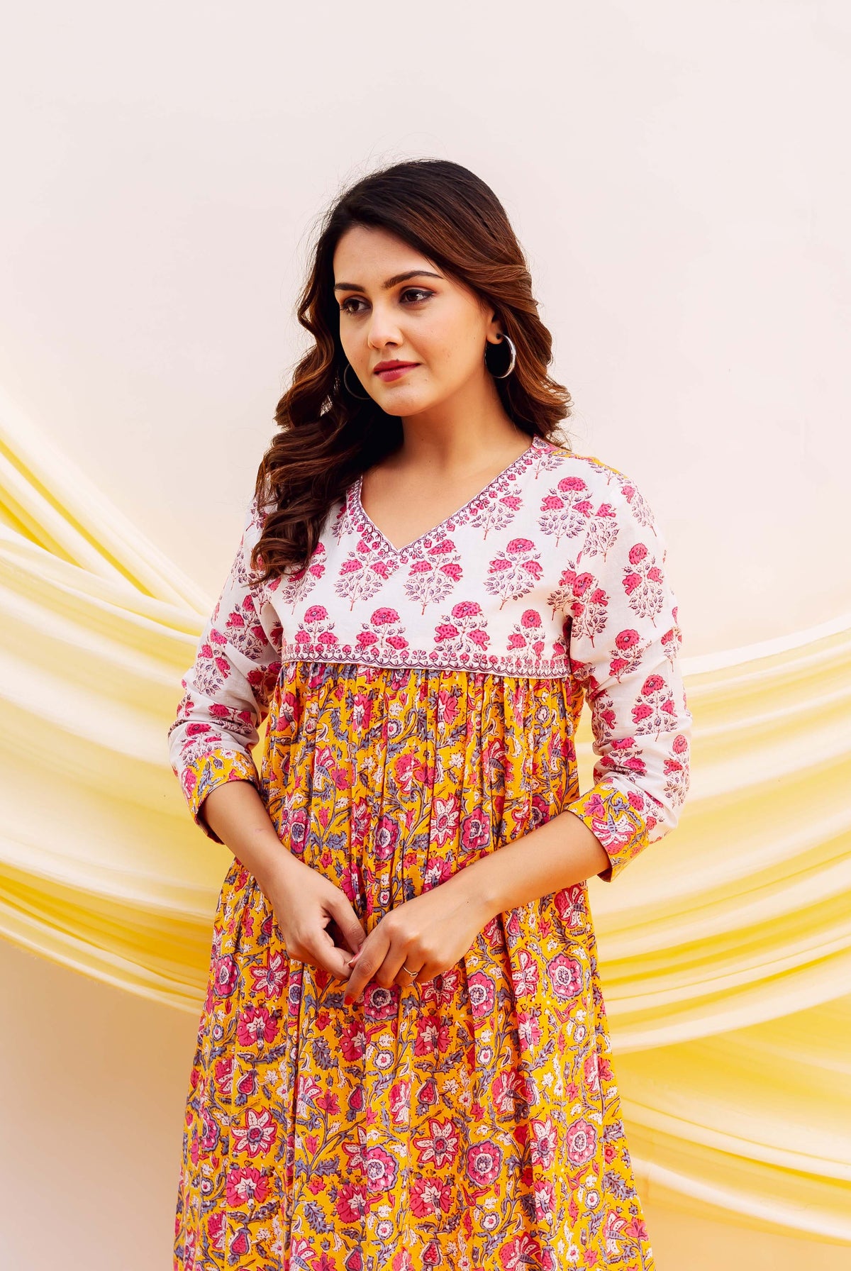 Front view model in a white, pink, and yellow floral hand-block printed cotton kurta.