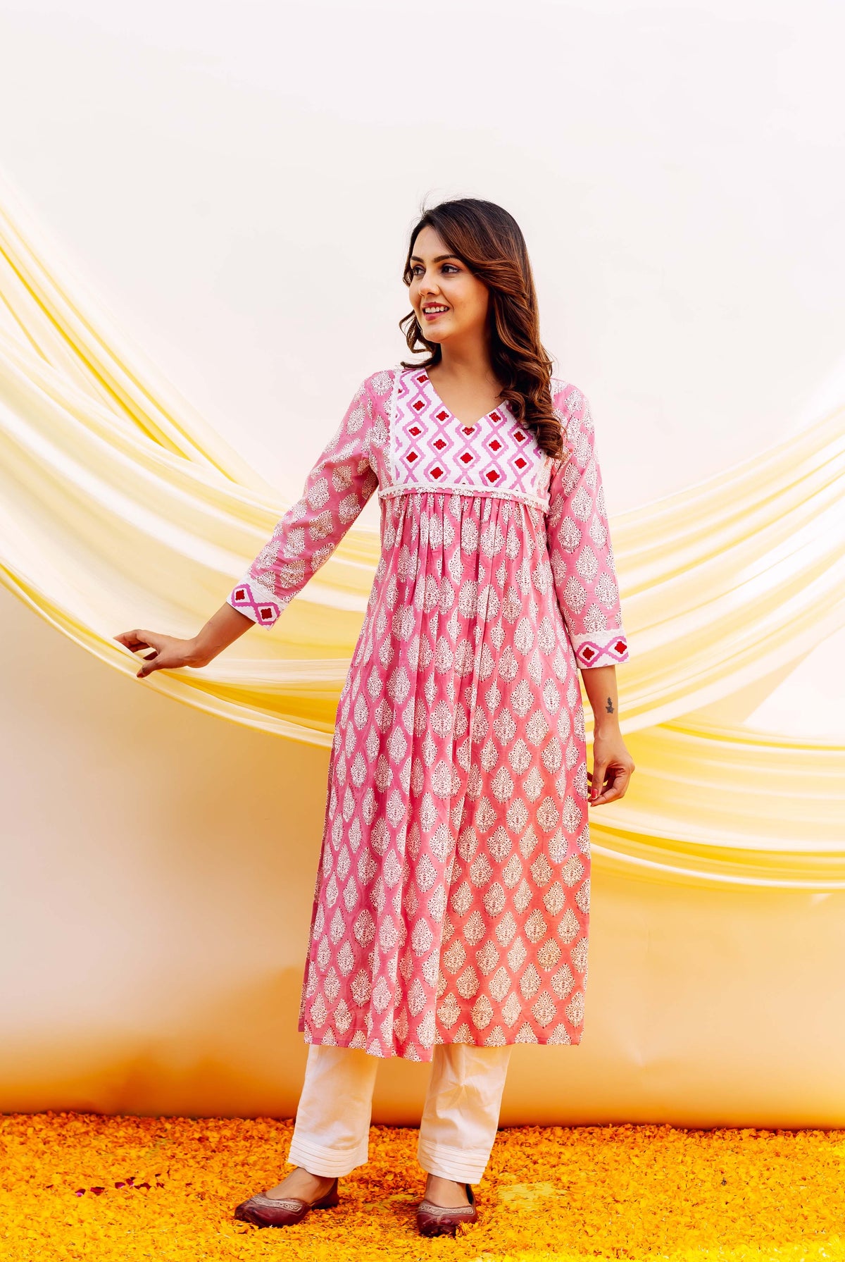 Front full look: Pink block printed cotton kurta with white leaf motifs and geometric yoke, white pants.