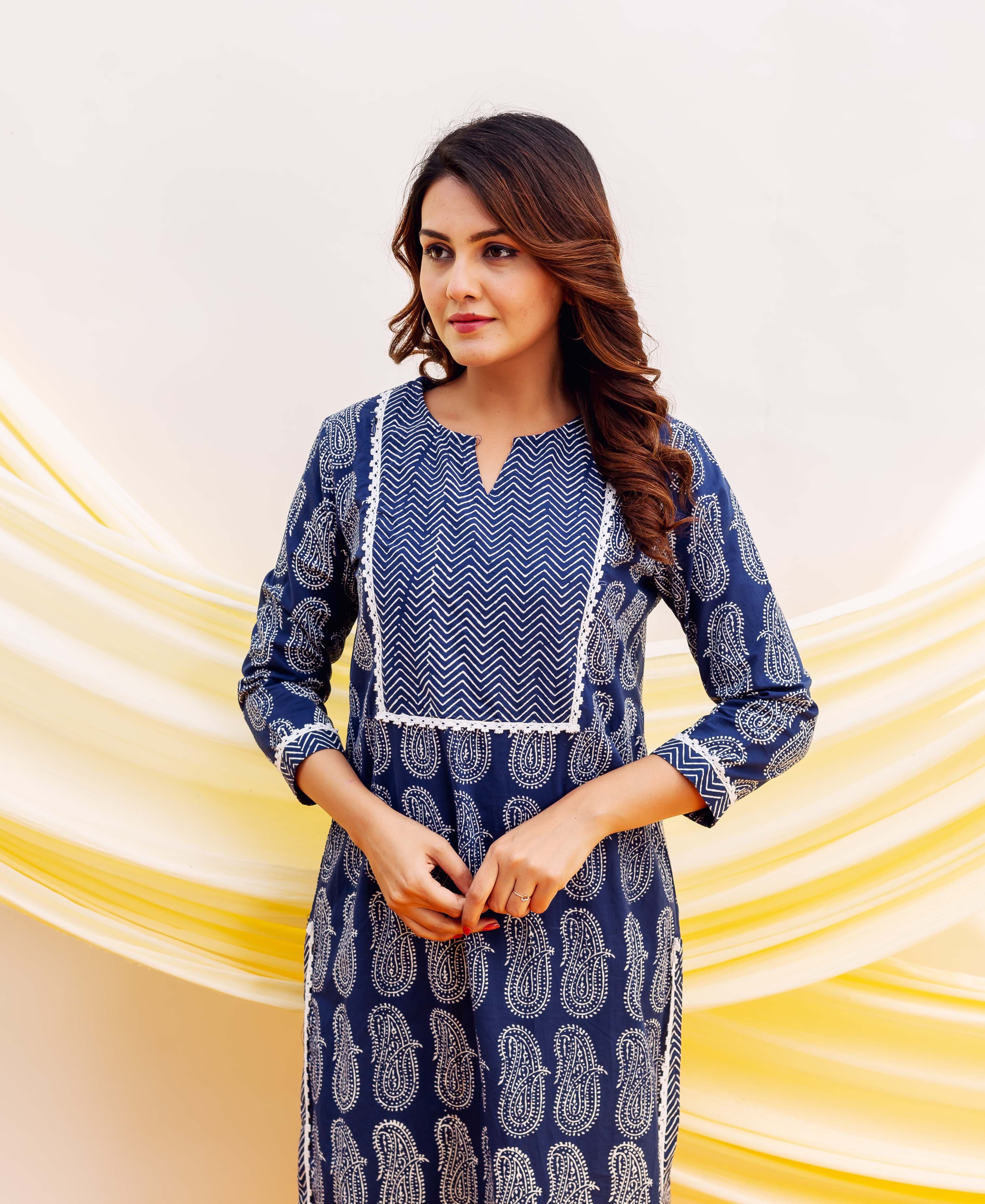 Blue and white block printed kurta on model, featuring paisley and chevron patterns.