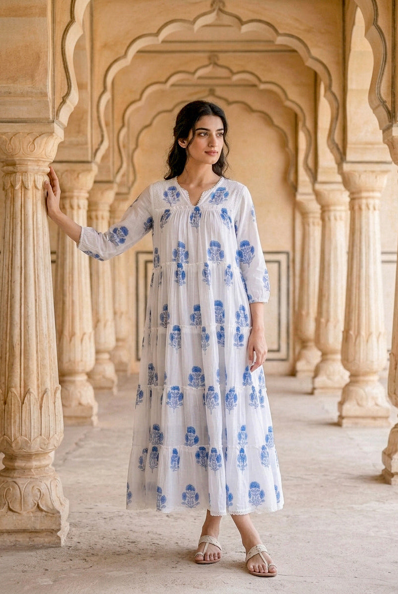 Full front view of model in white and blue floral hand block print tiered maxi dress.
