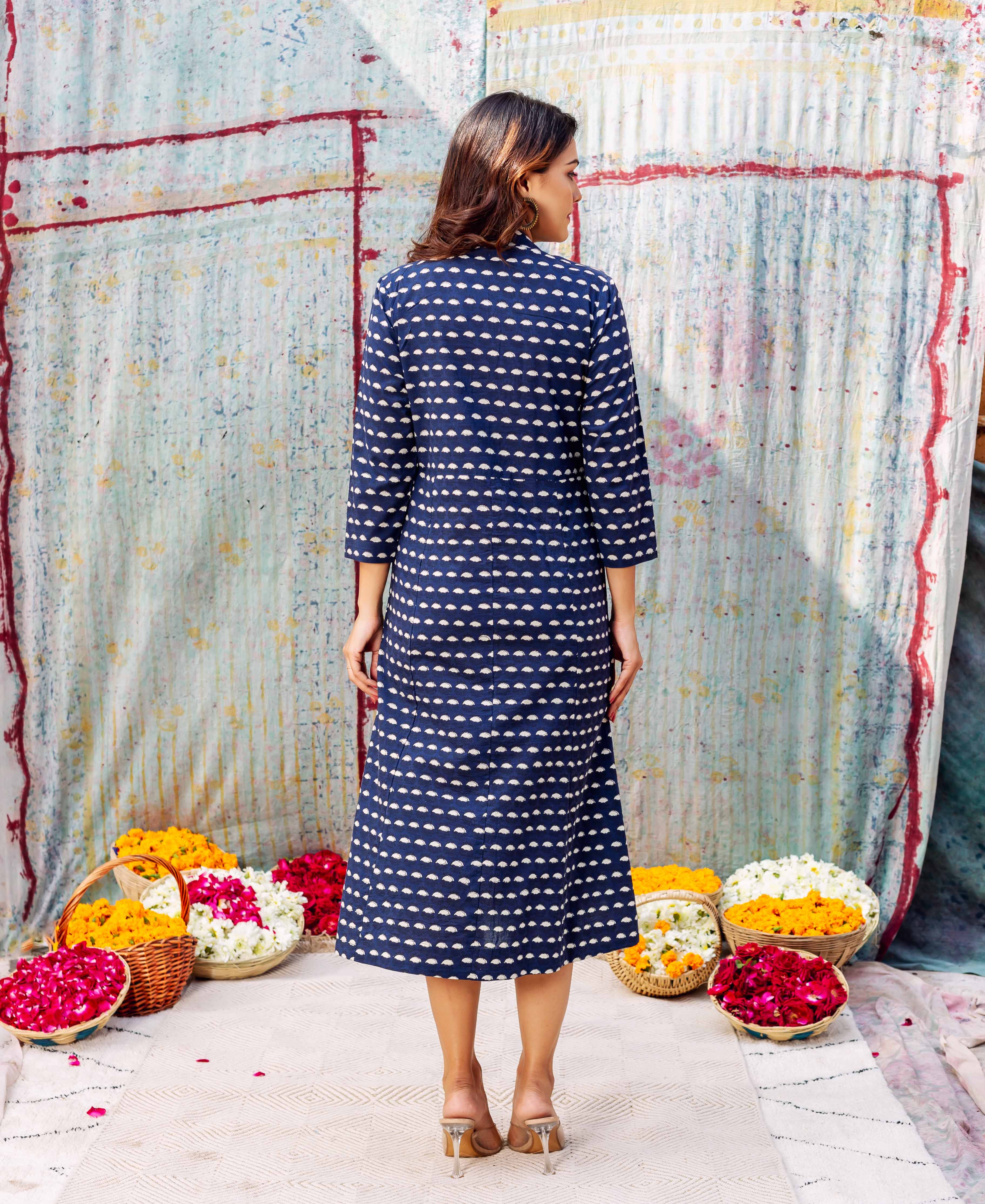 Back view of a woman in an indigo blue ethnic dress with white hand-block print.