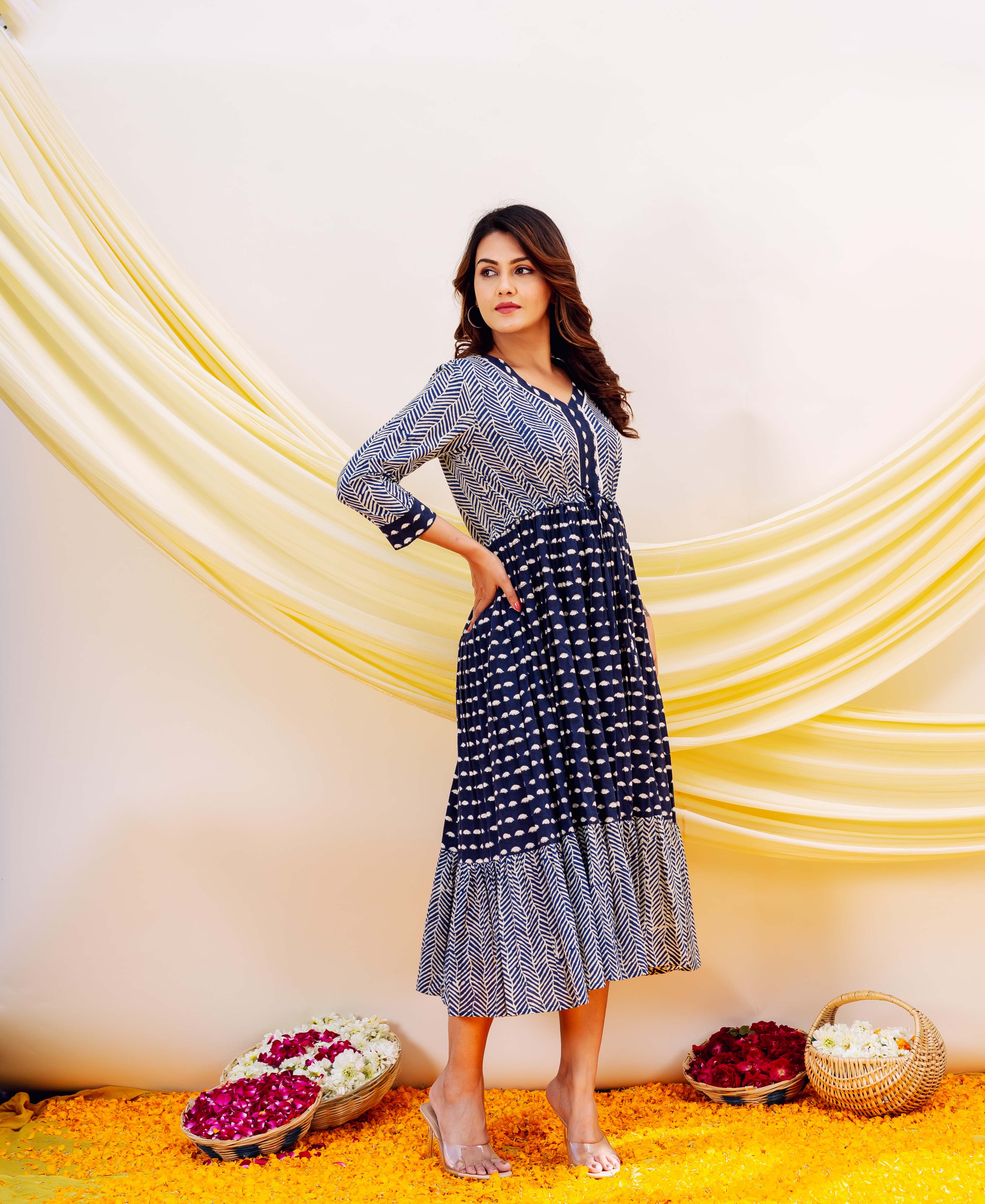 Full look: Model in indigo tiered midi dress with chevron and dot block prints.