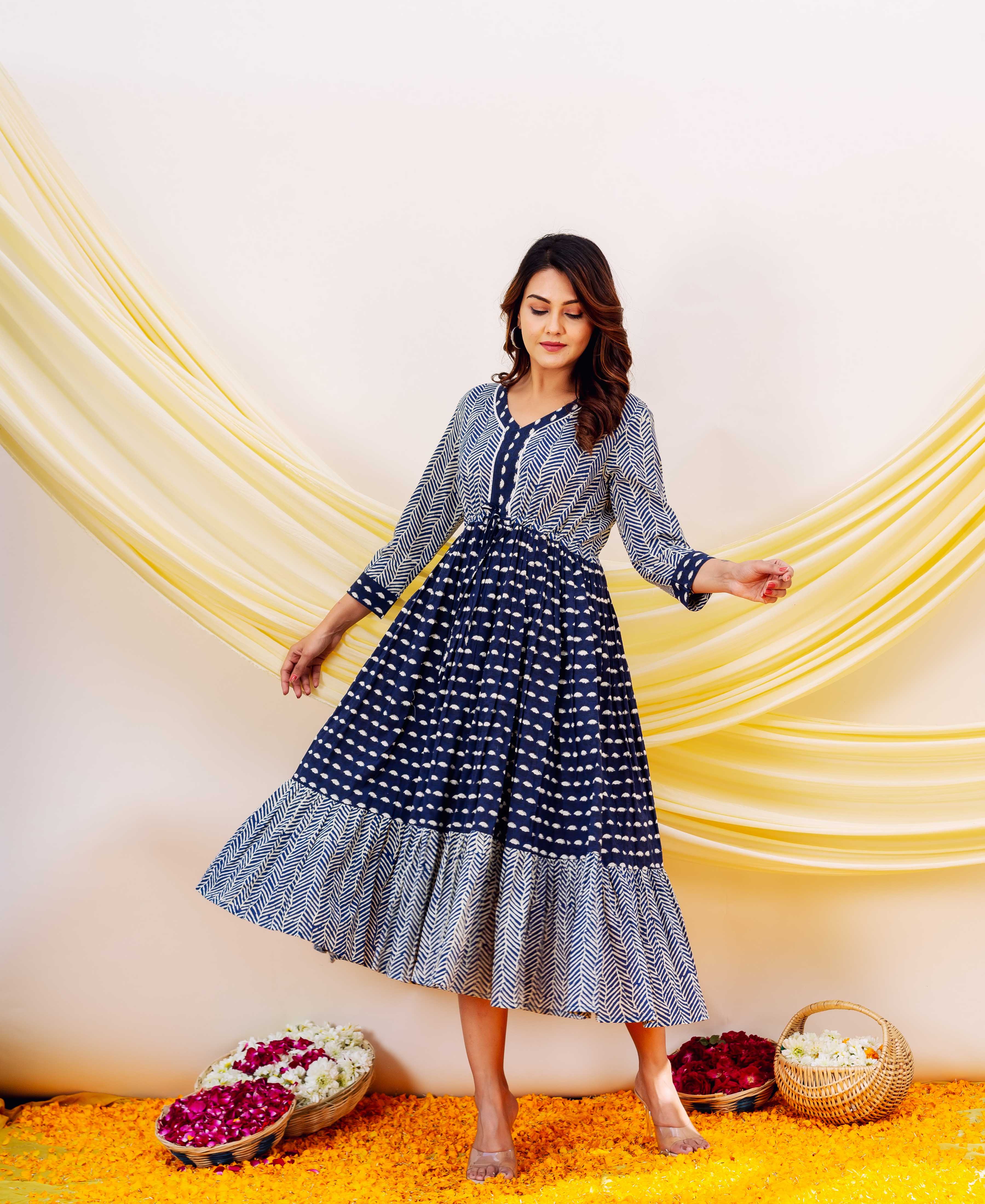 Front full look of model in an indigo and white V-neck block-printed tiered dress.
