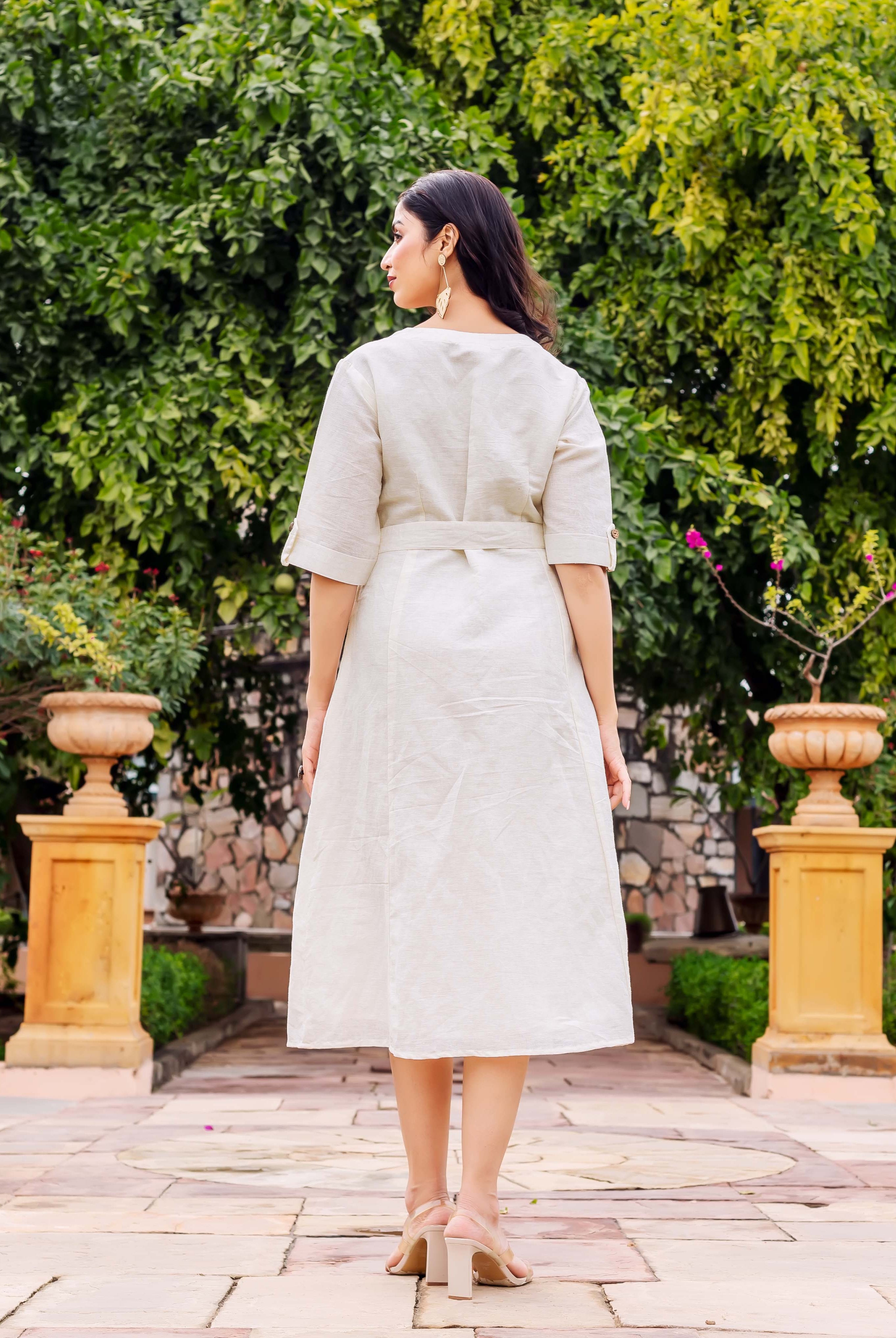 Back view of model wearing a light beige linen midi dress with a self-tie belt.