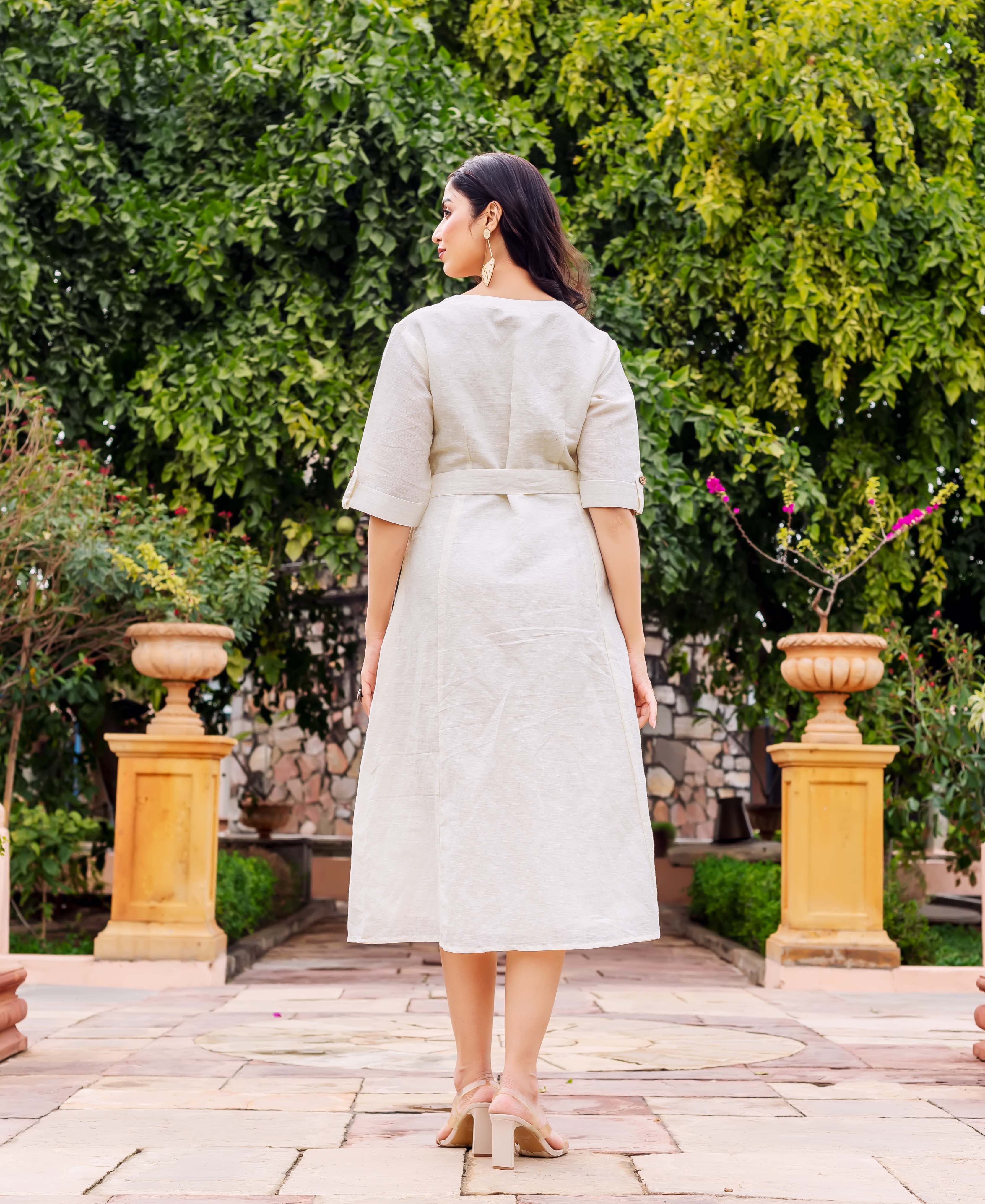 Back view of model wearing a light beige linen midi dress with a self-tie belt.