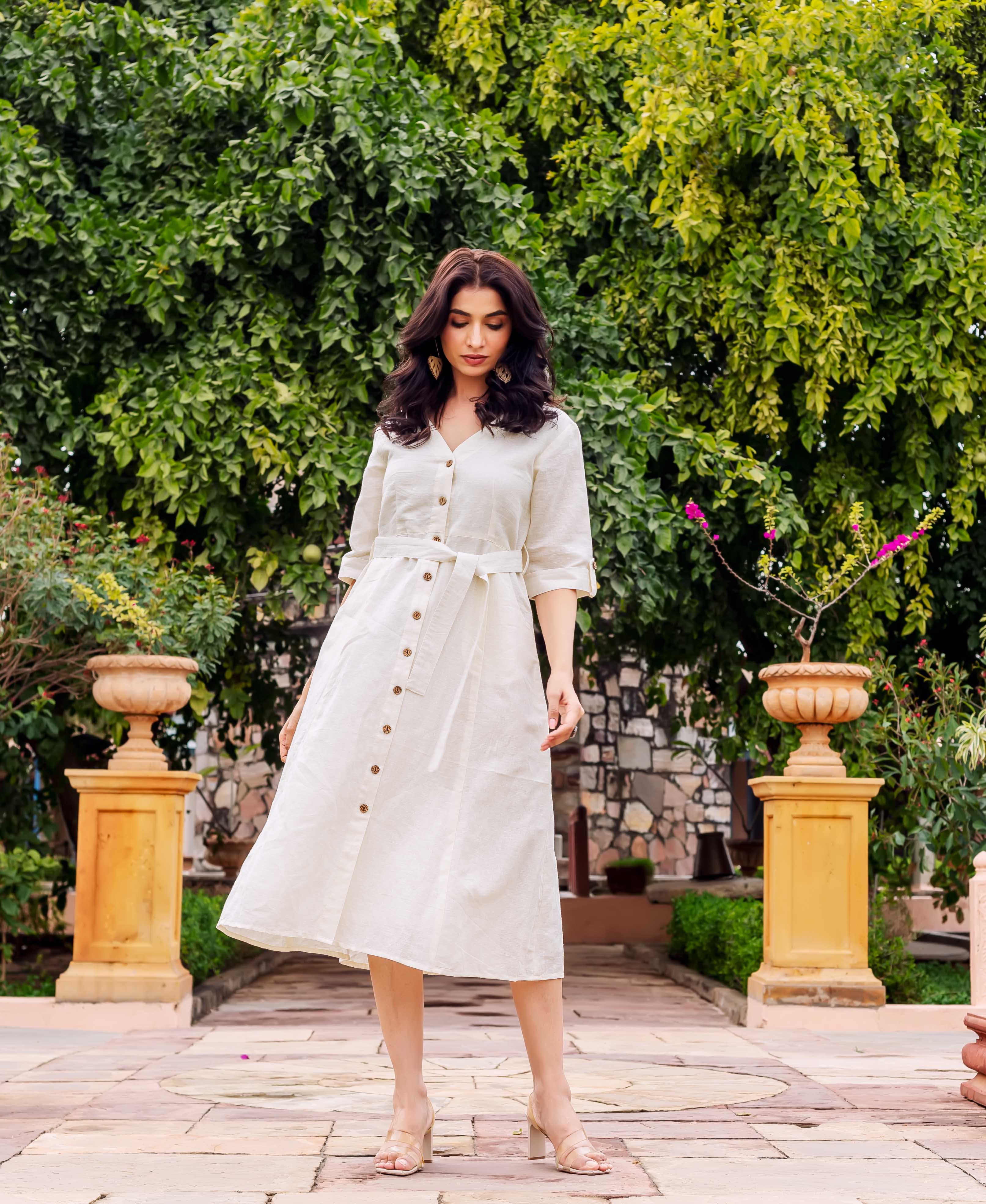 Model in off-white linen midi dress, V-neck, belted waist, and button-down front.