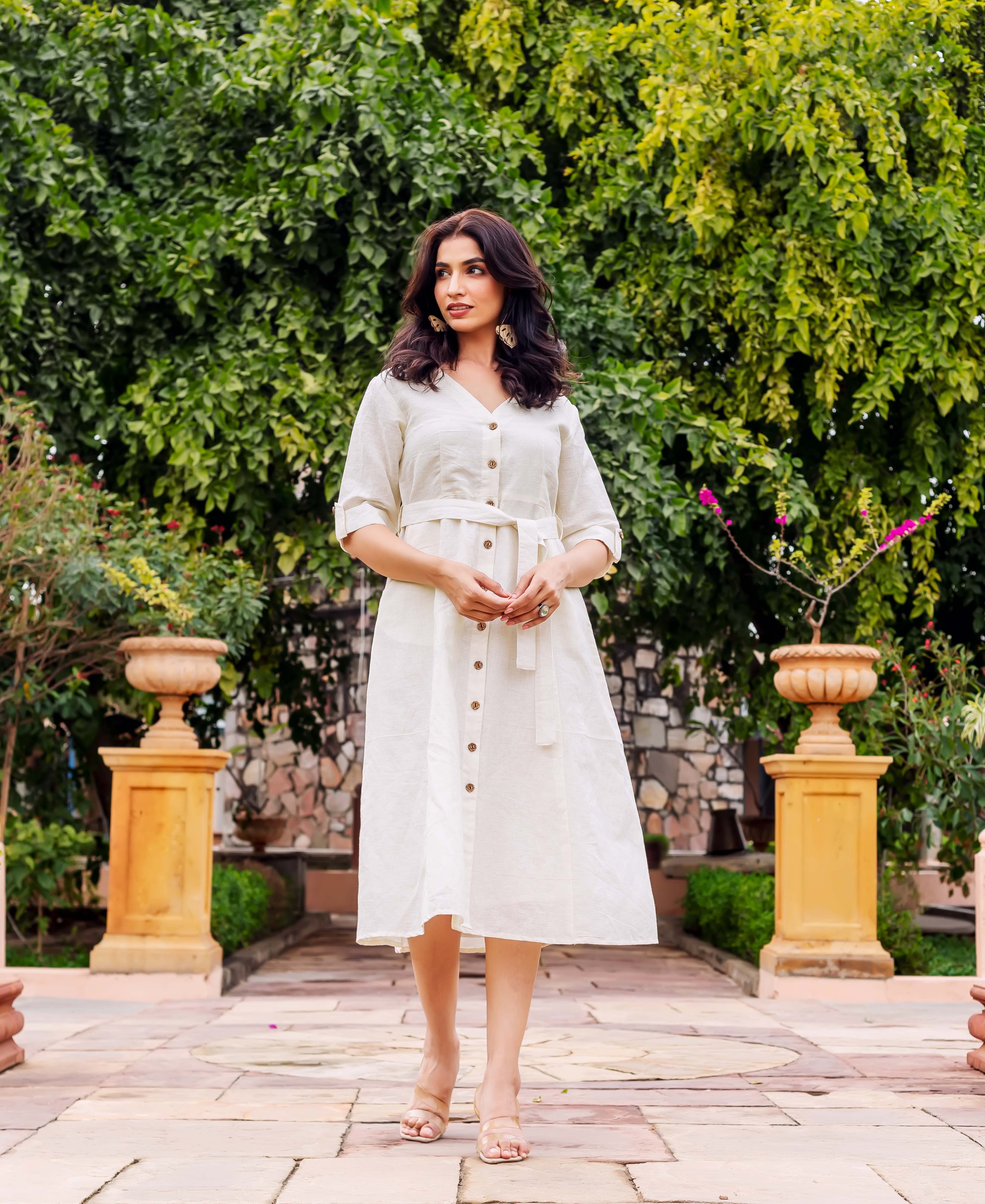 Off-white textured linen midi dress on model, V-neck, button-front, belted, and rolled sleeves.
