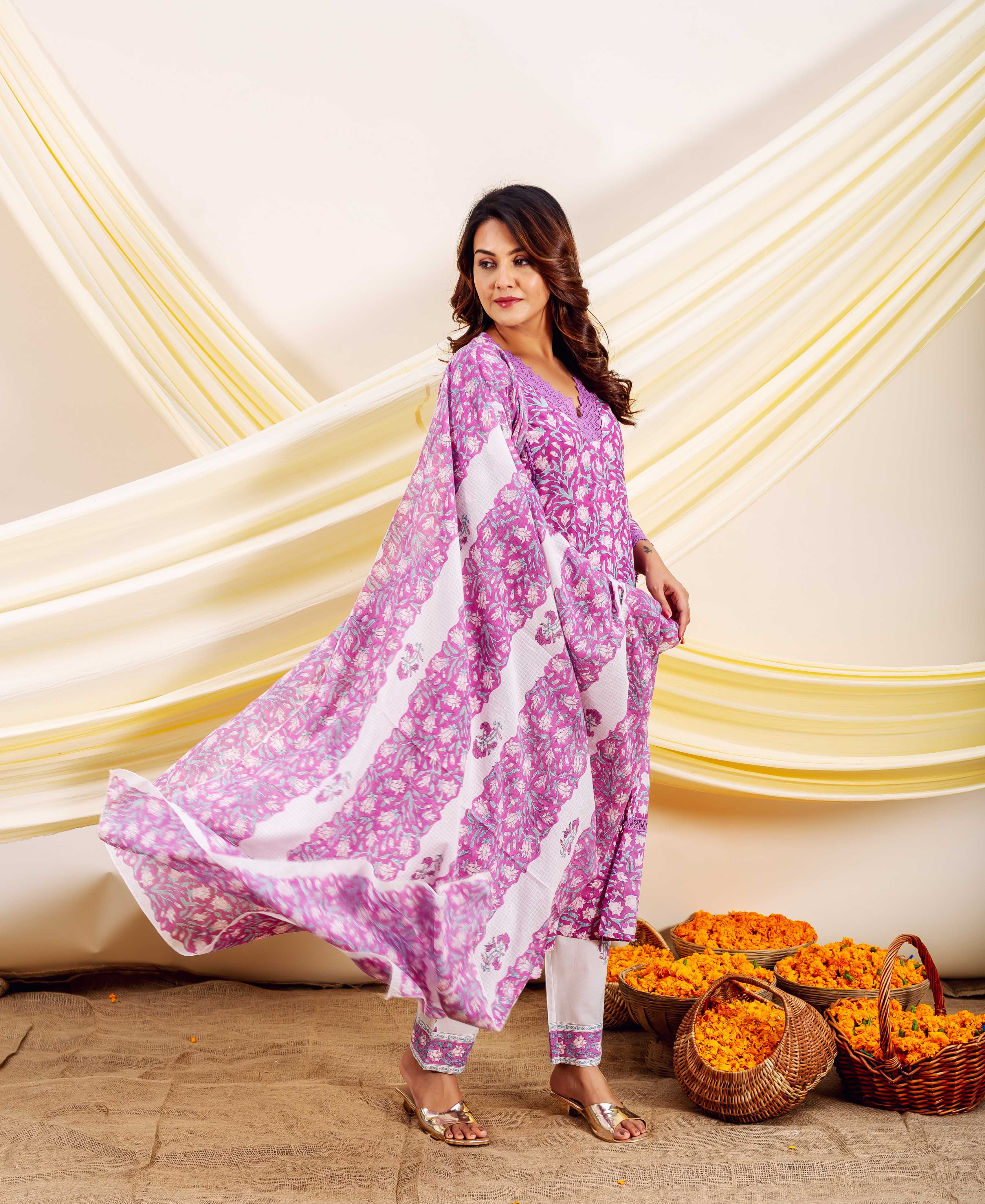 Model in flowing purple and white striped floral block-printed cotton ethnic ensemble.