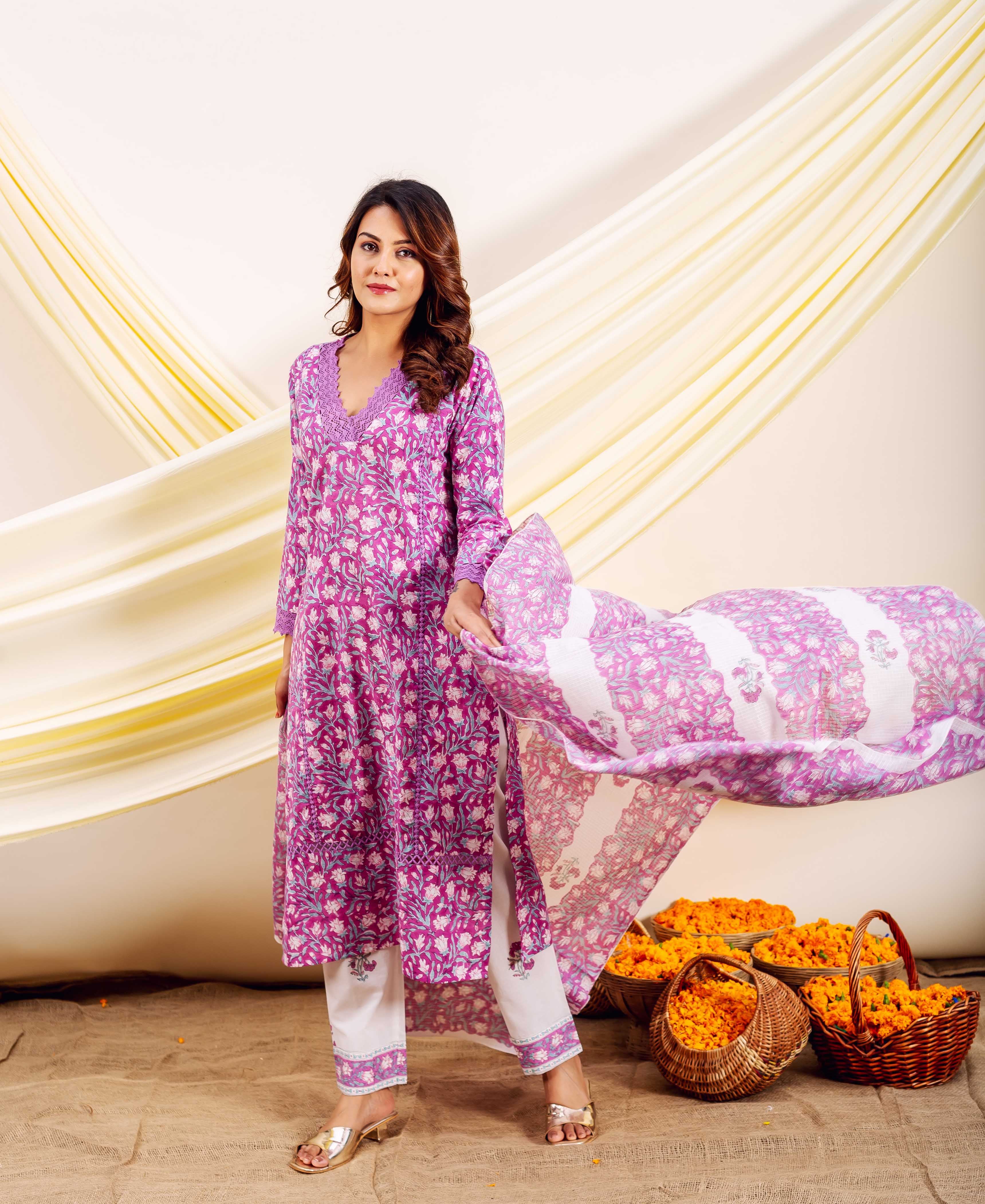 Full shot of model in magenta hand-block printed floral cotton kurta set with white pants.