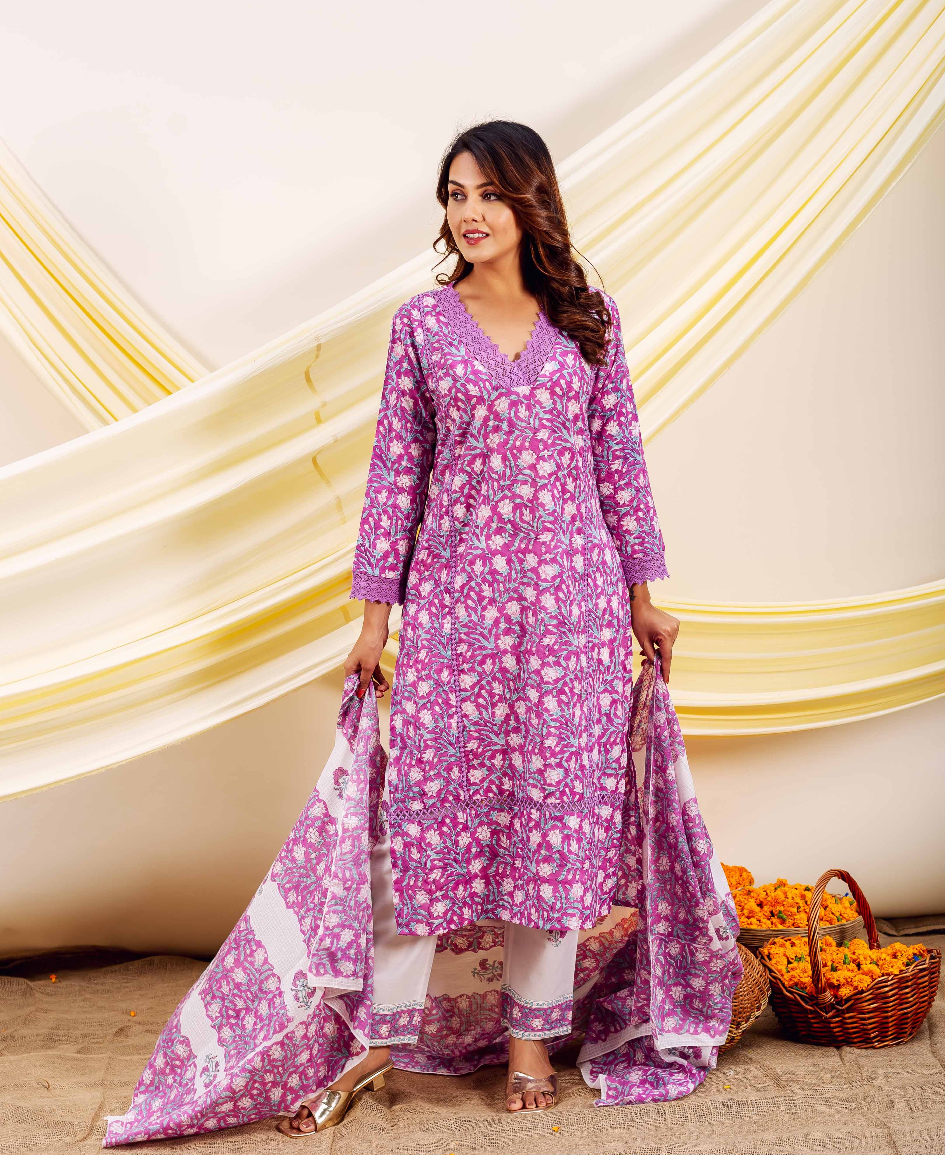 A model wearing a pink and white floral print ensemble with a matching dupatta.