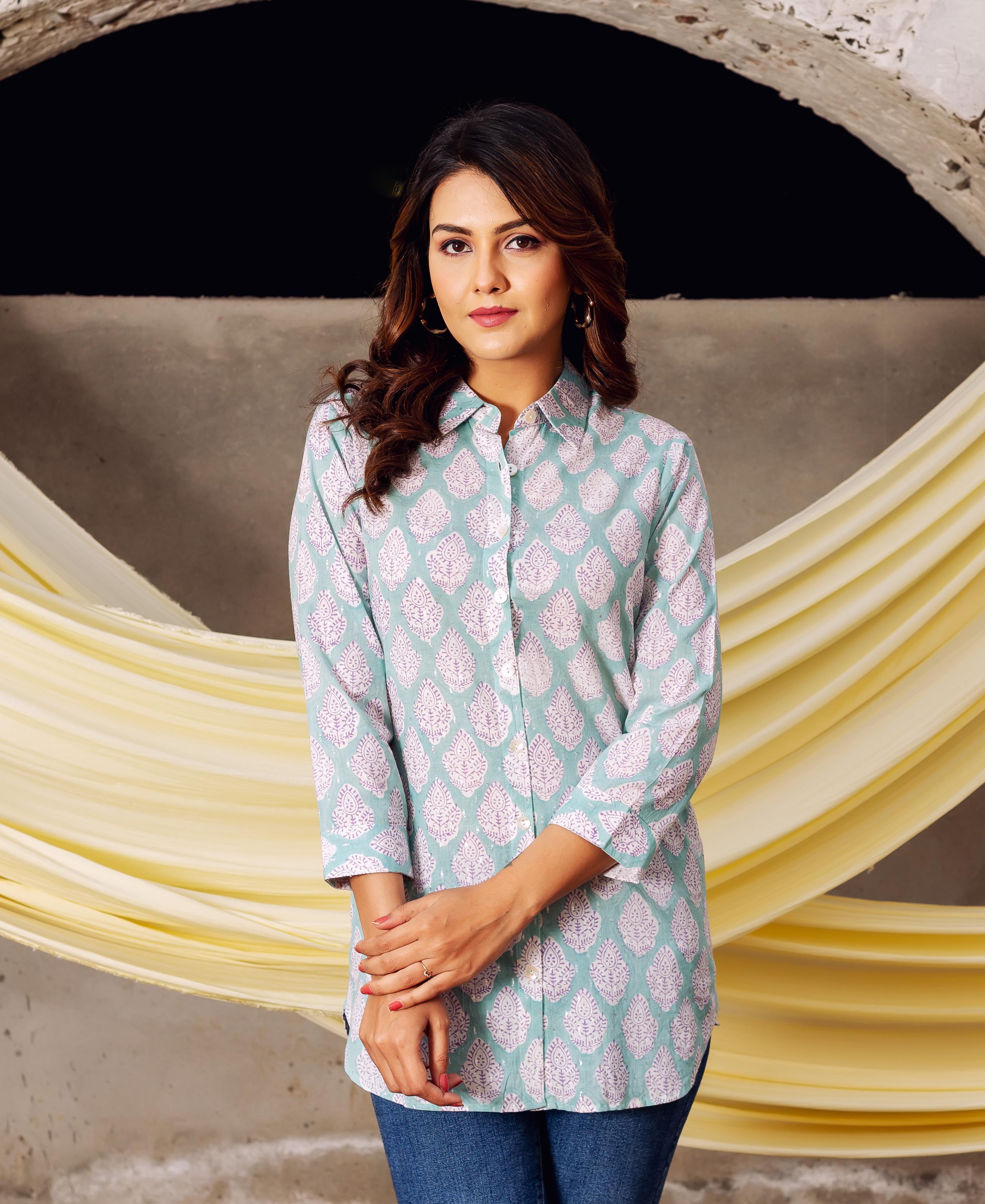 Front view of model wearing an aqua hand-block-printed ethnic tunic with light purple motifs.