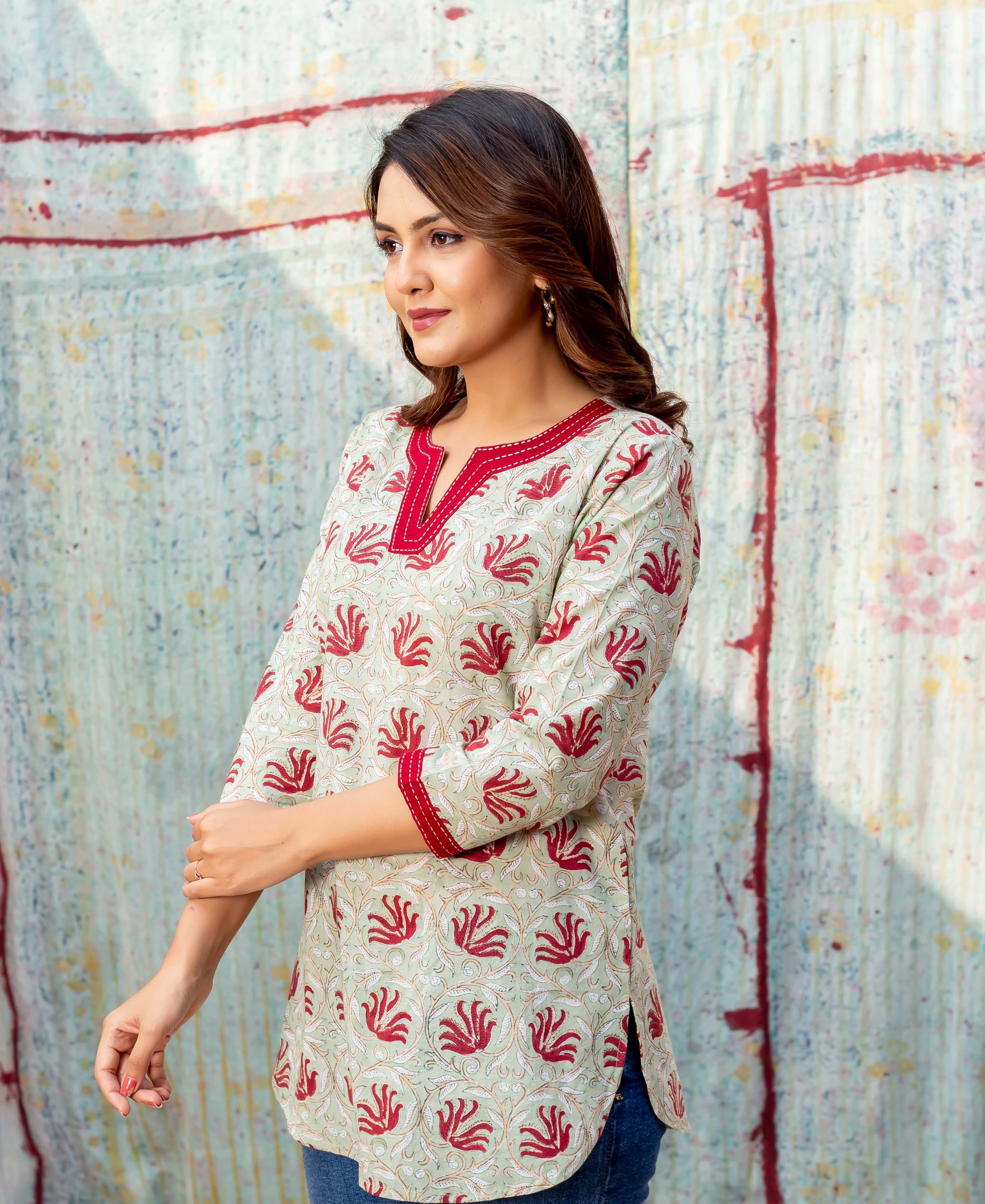 Side profile of woman in Meadow Green top with red ethnic block print.