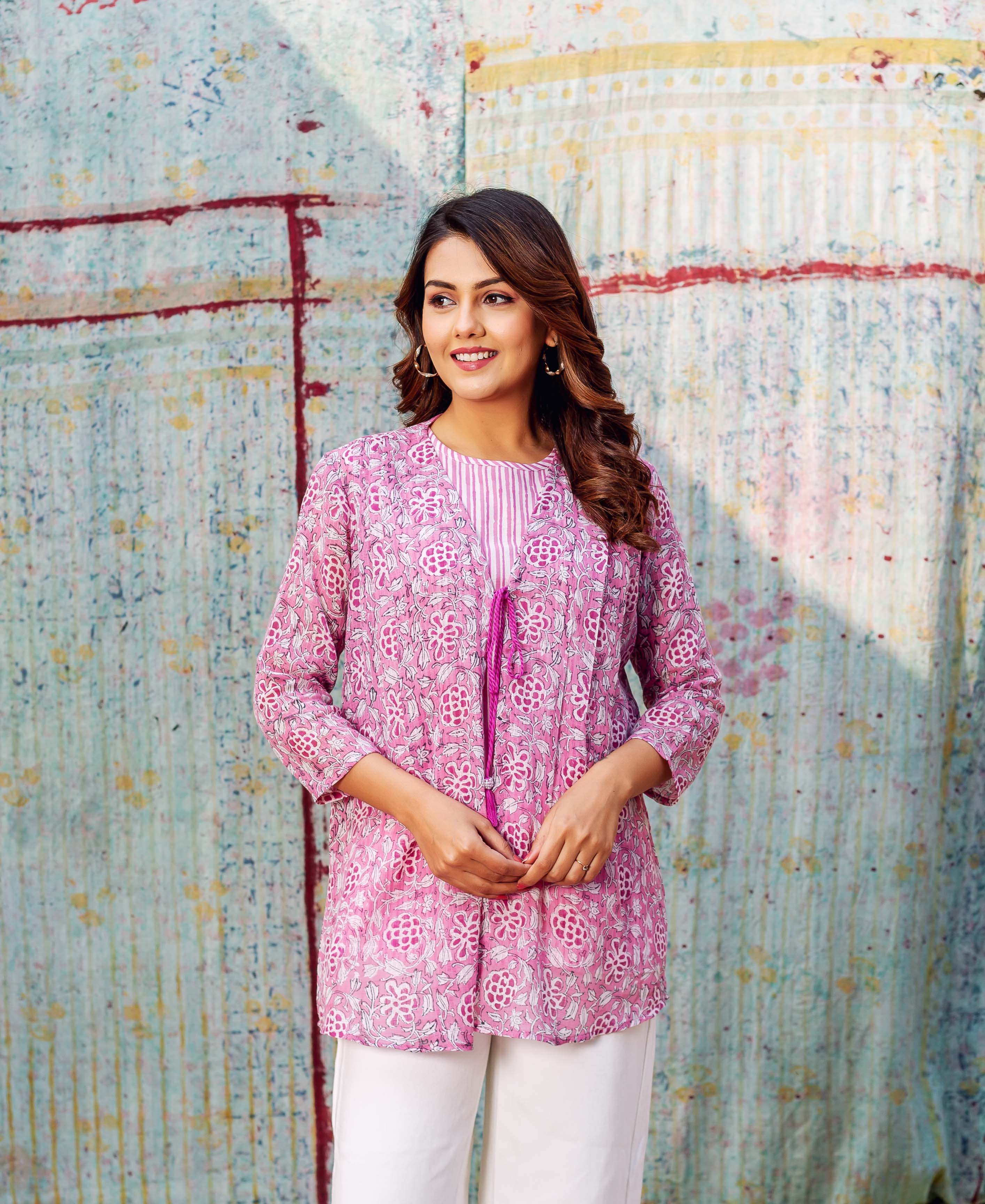Front view of model wearing blush pink floral hand-block printed layered top, white pants.