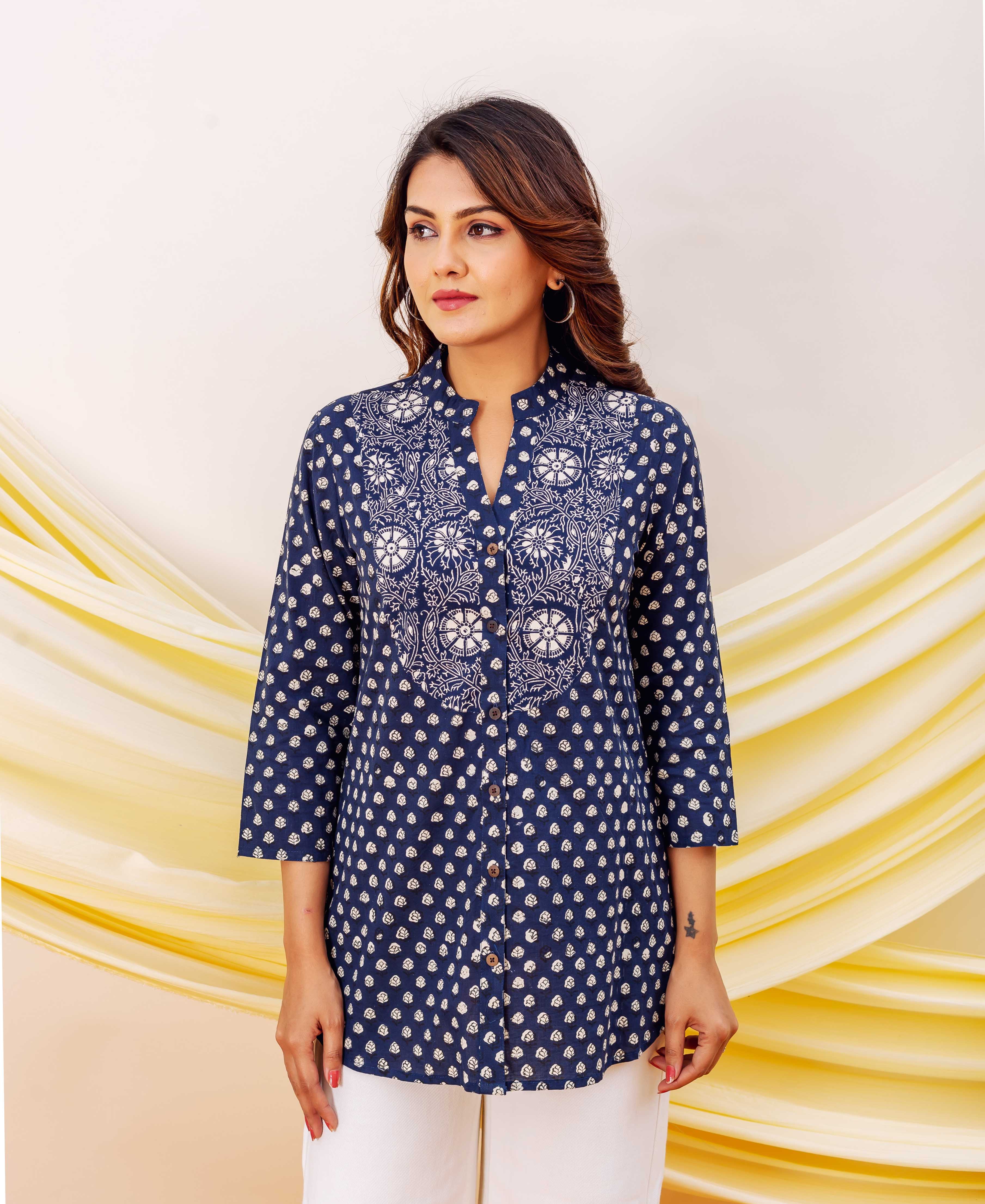 Model in indigo block-printed cotton top with white floral yoke and booti pattern.