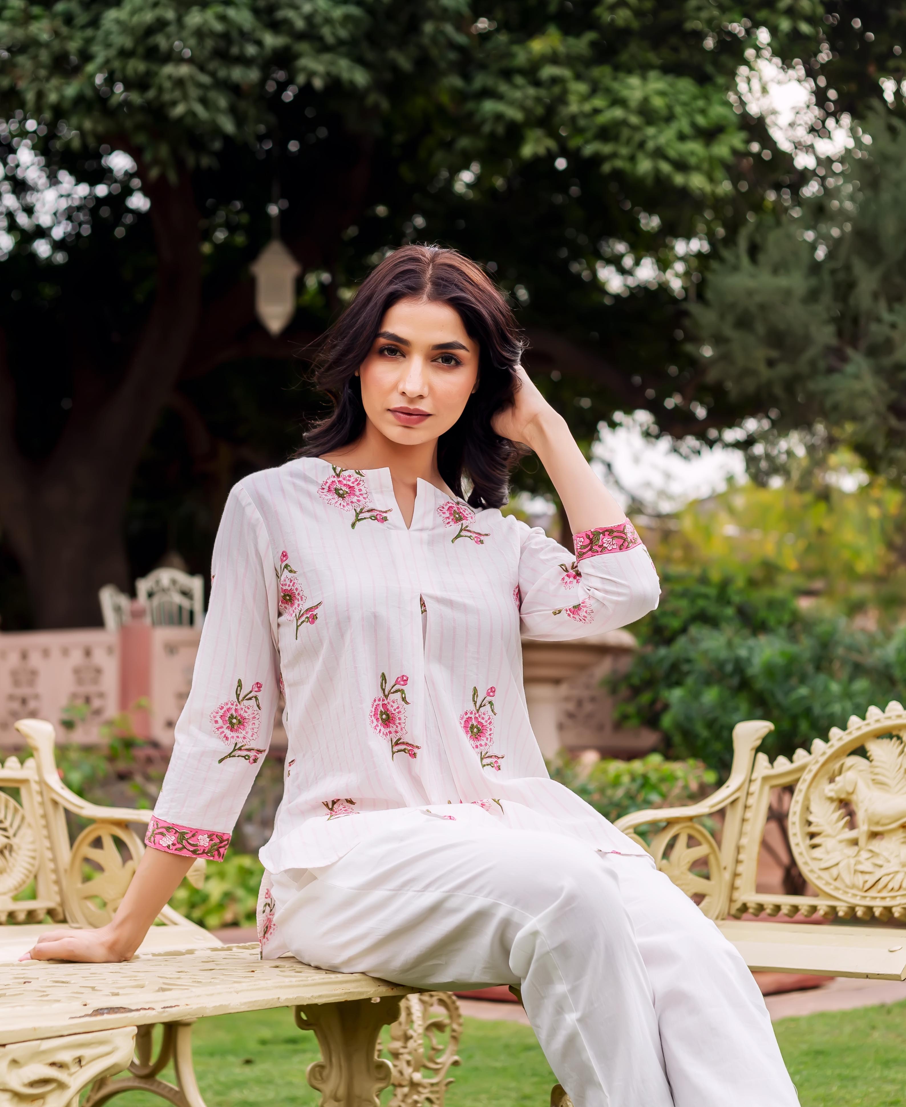 Front view model in white striped tunic with pink floral block print and white pants.