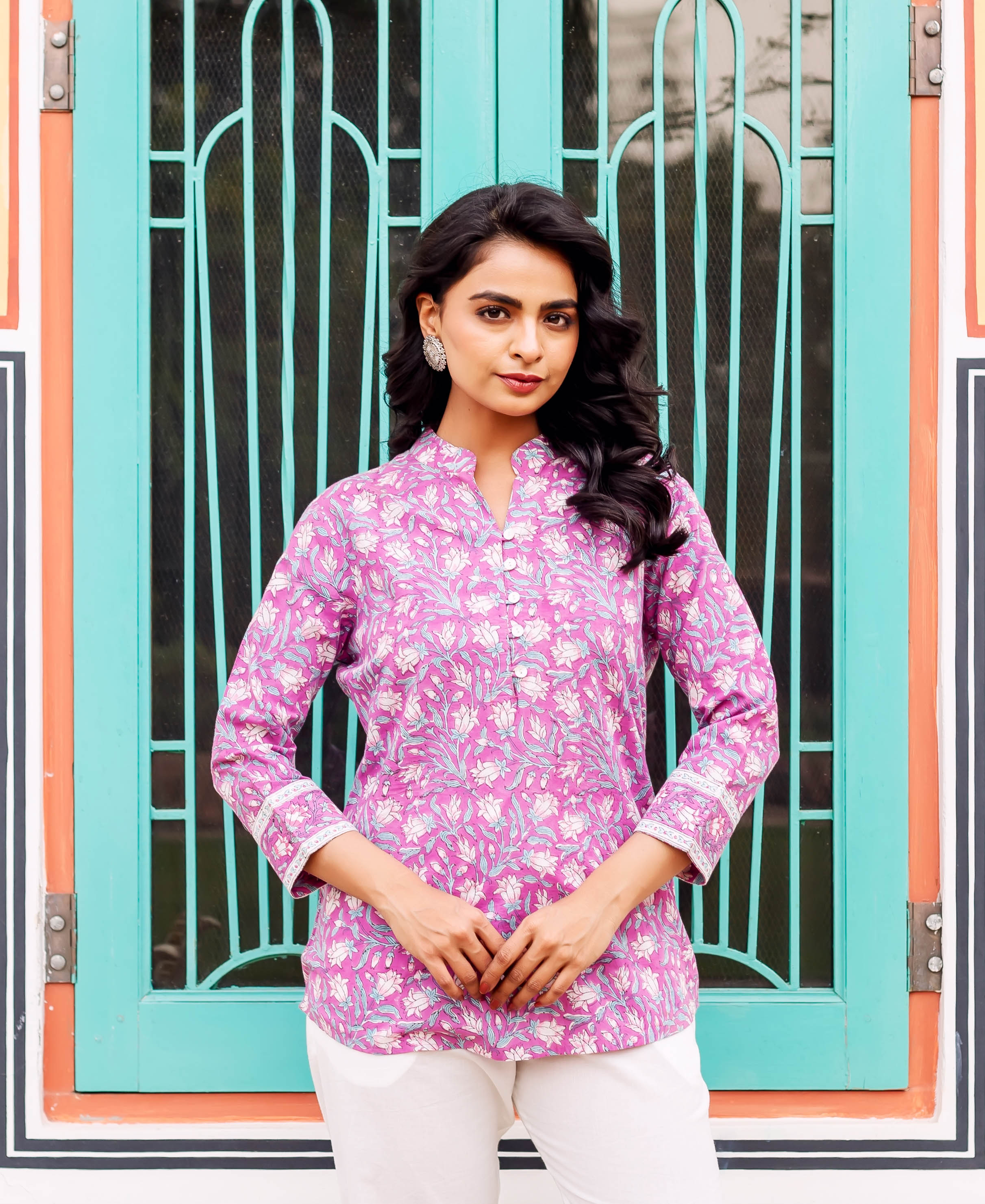 Model wearing a hand-block printed floral purple cotton tunic, front view.
