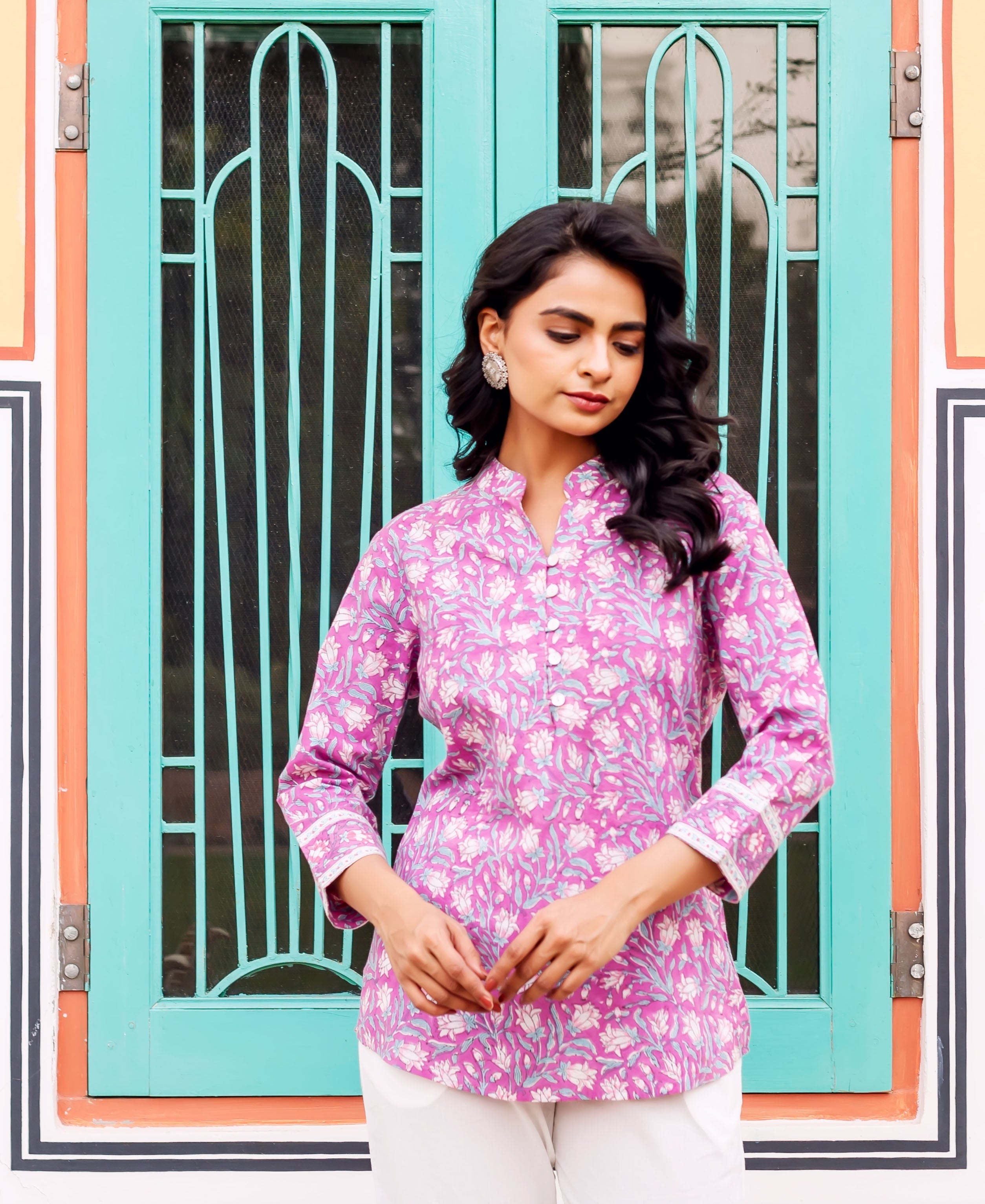 Woman modeling 3/4 sleeve floral purple cotton tunic with white lotus print.
