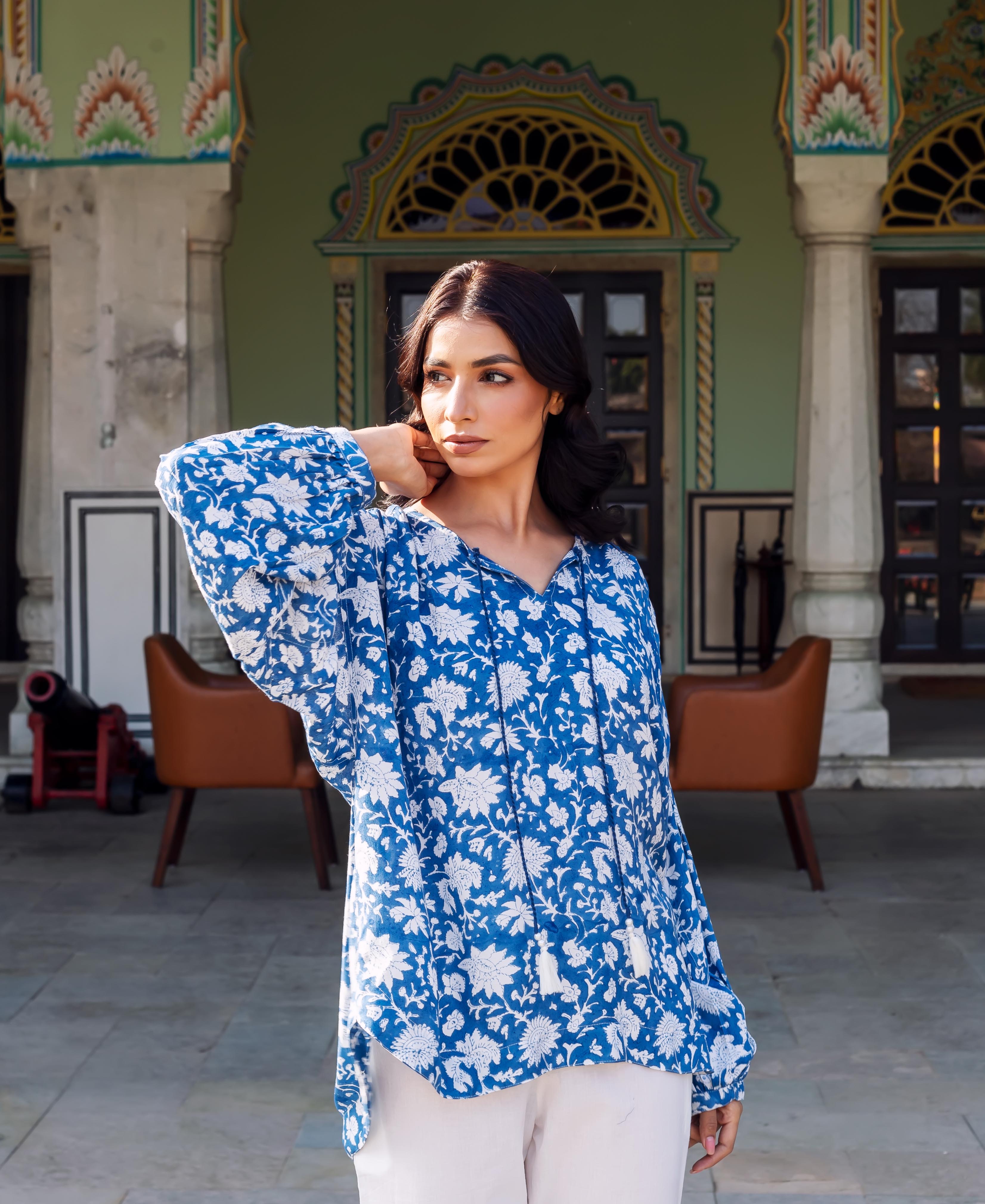 Model wearing a blue and white hand-block printed floral tunic with tie-up V-neck.