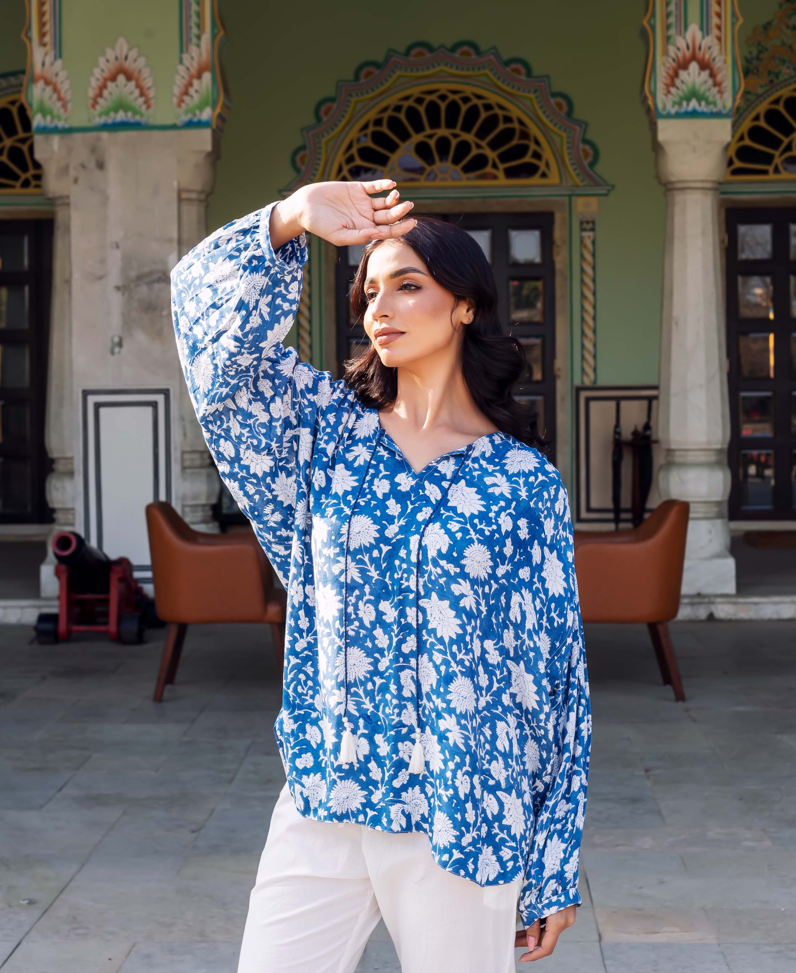 Three-quarter shot of model wearing blue and white hand-block-printed ethnic floral tunic.
